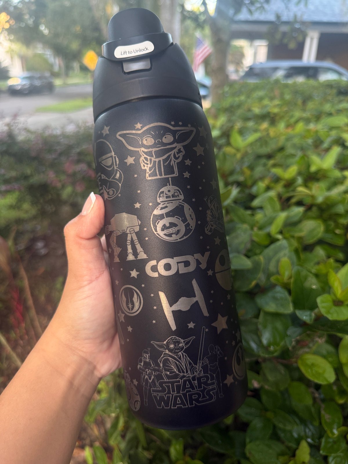 Side view of a black Owala with engraved galaxy and droid icons