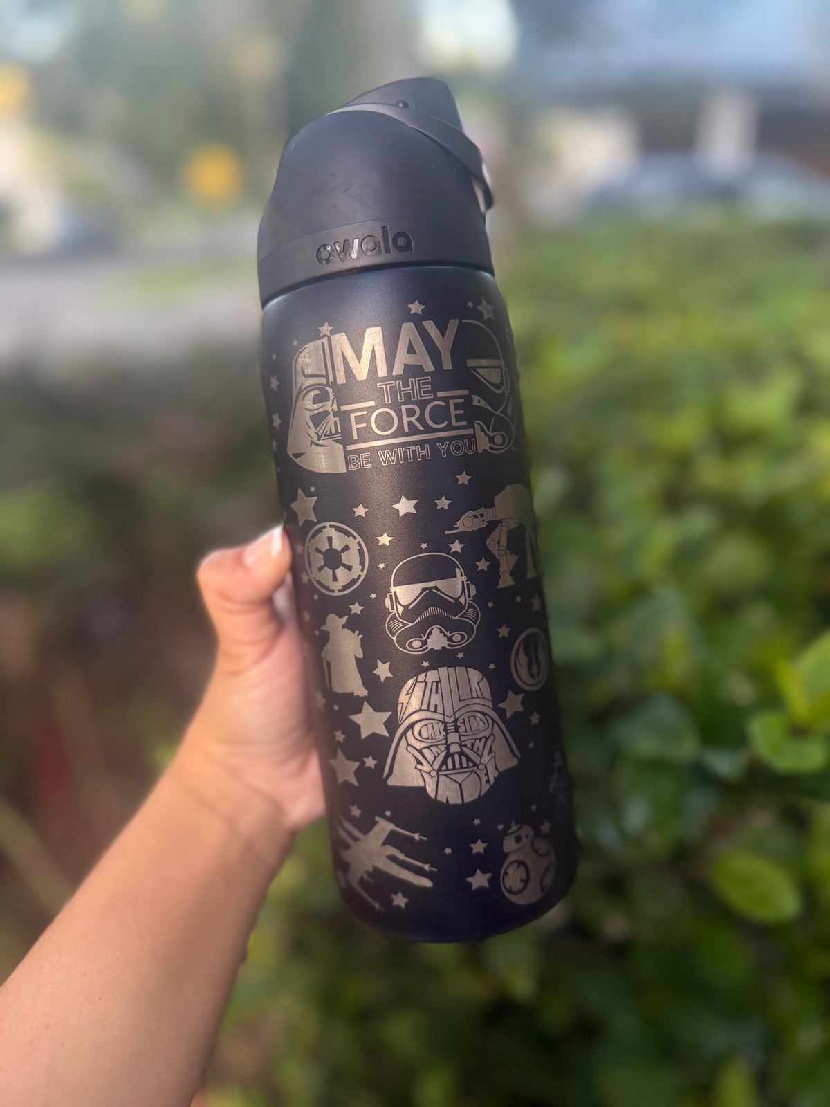 Close-up of the 'May the Force' engraving on a black Owala