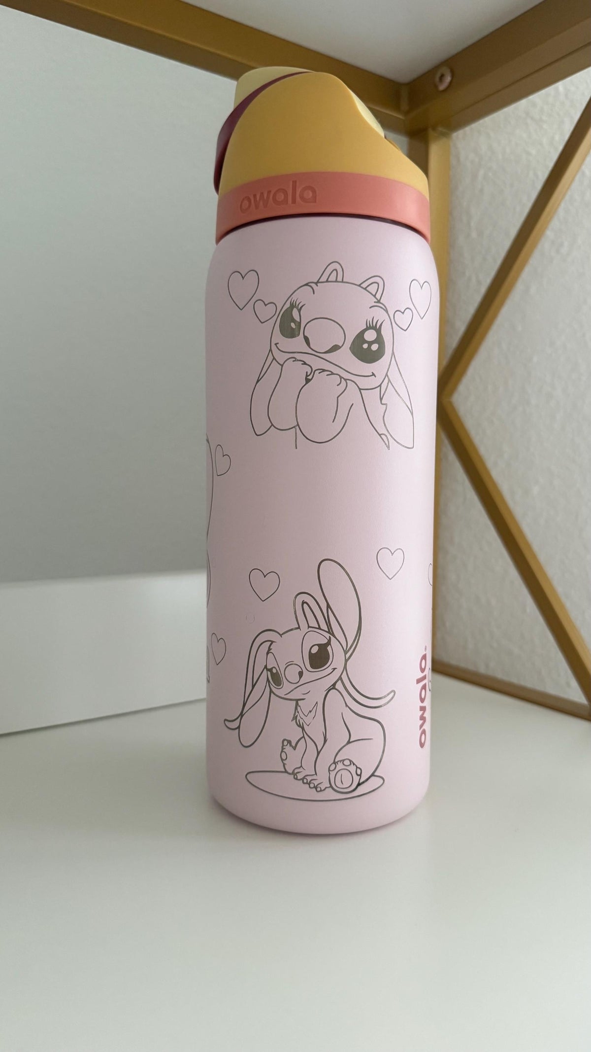 Back of a light pink Owala FreeSip with engraved Angel artwork