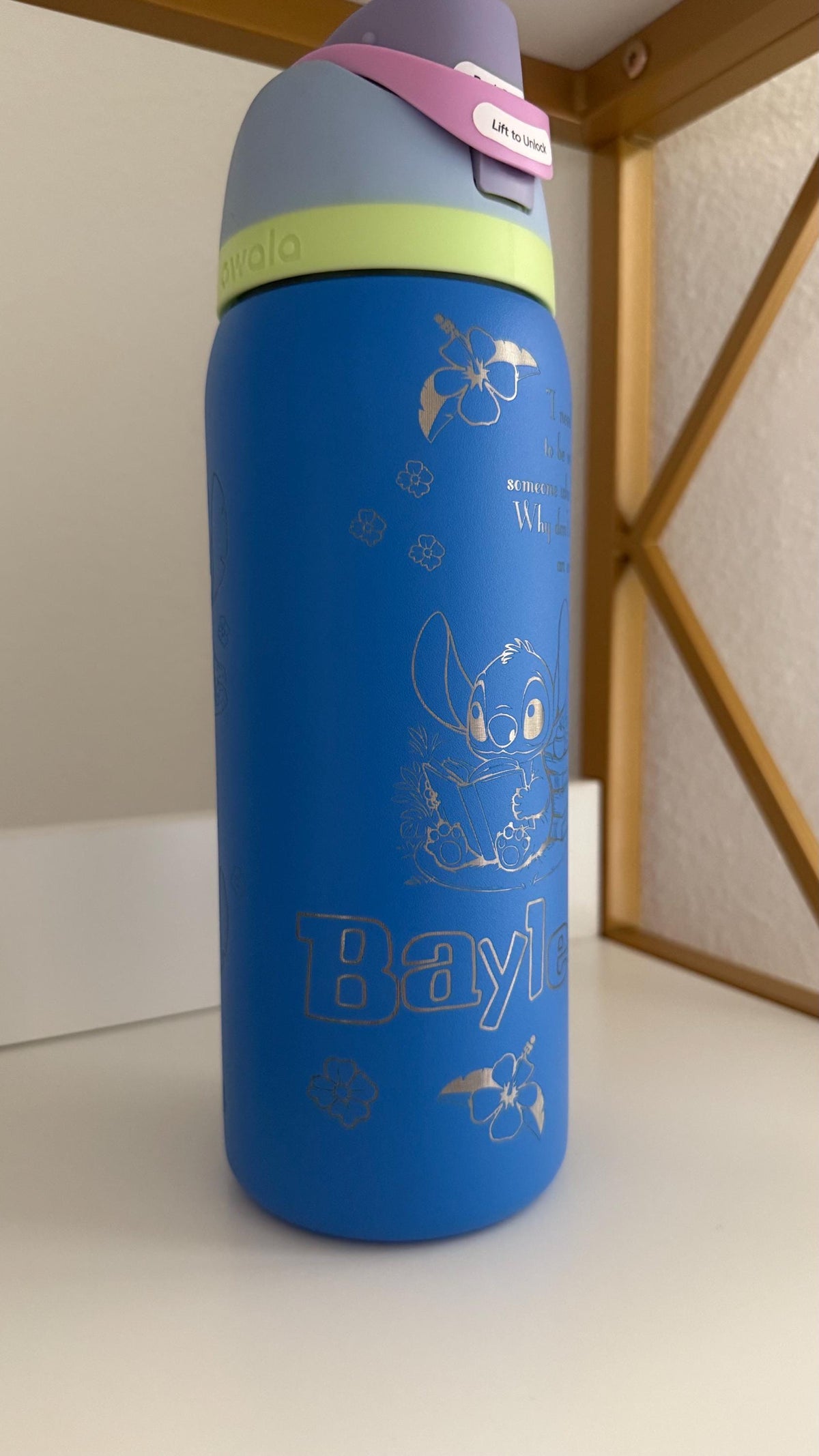 Side view of a blue Owala FreeSip with a Stitch-inspired laser engraving
