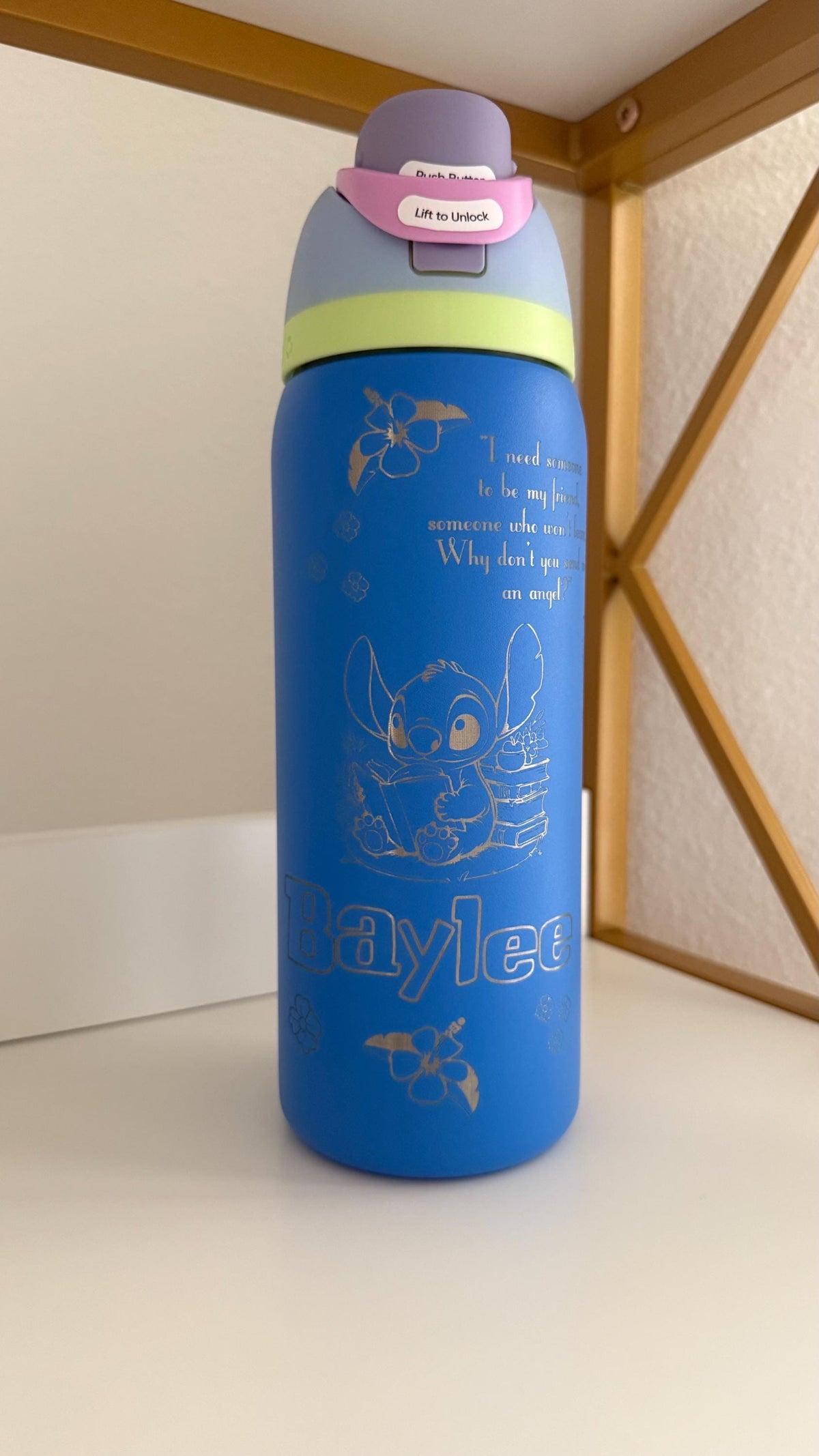 Blue Owala FreeSip with a laser engraved name and Stitch design