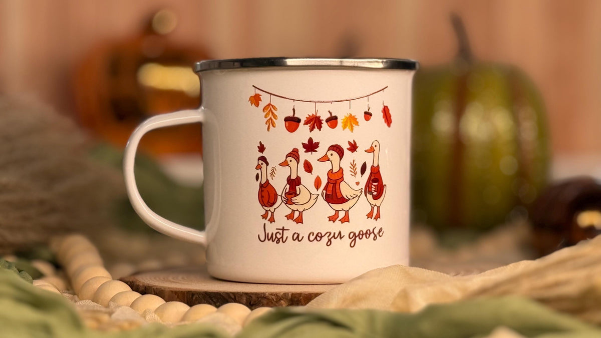 Close-up of the autumn geese and leaves print on a white enamel mug
