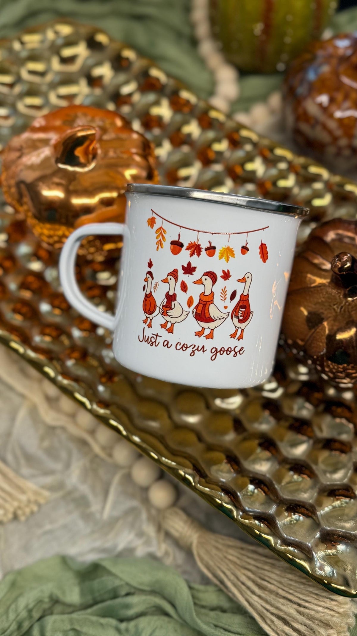 Cozy goose enamel coffee mug on a gold tray with fall decor