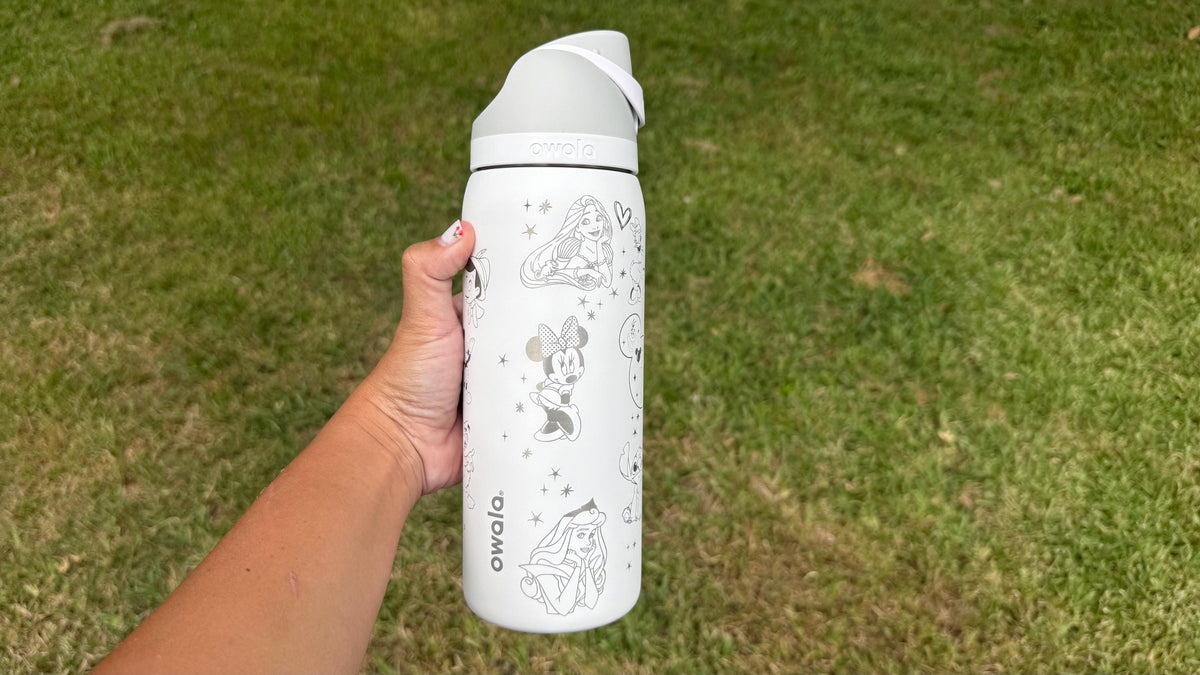 White engraved Owala FreeSip held outdoors