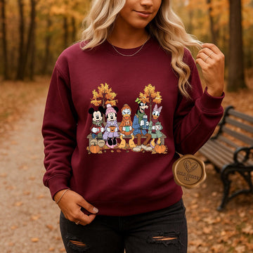 Woman wearing a maroon Mickey and Friends-inspired fall sweatshirt outdoors