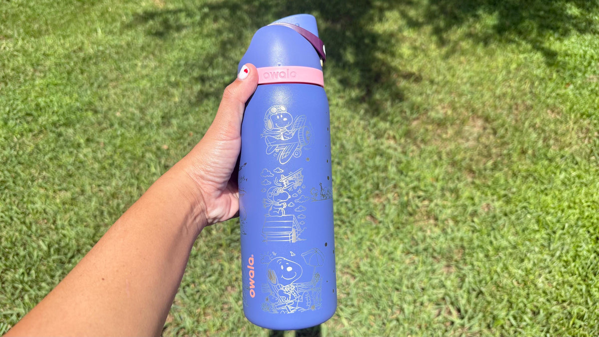 Periwinkle engraved Snoopy Owala held outdoors