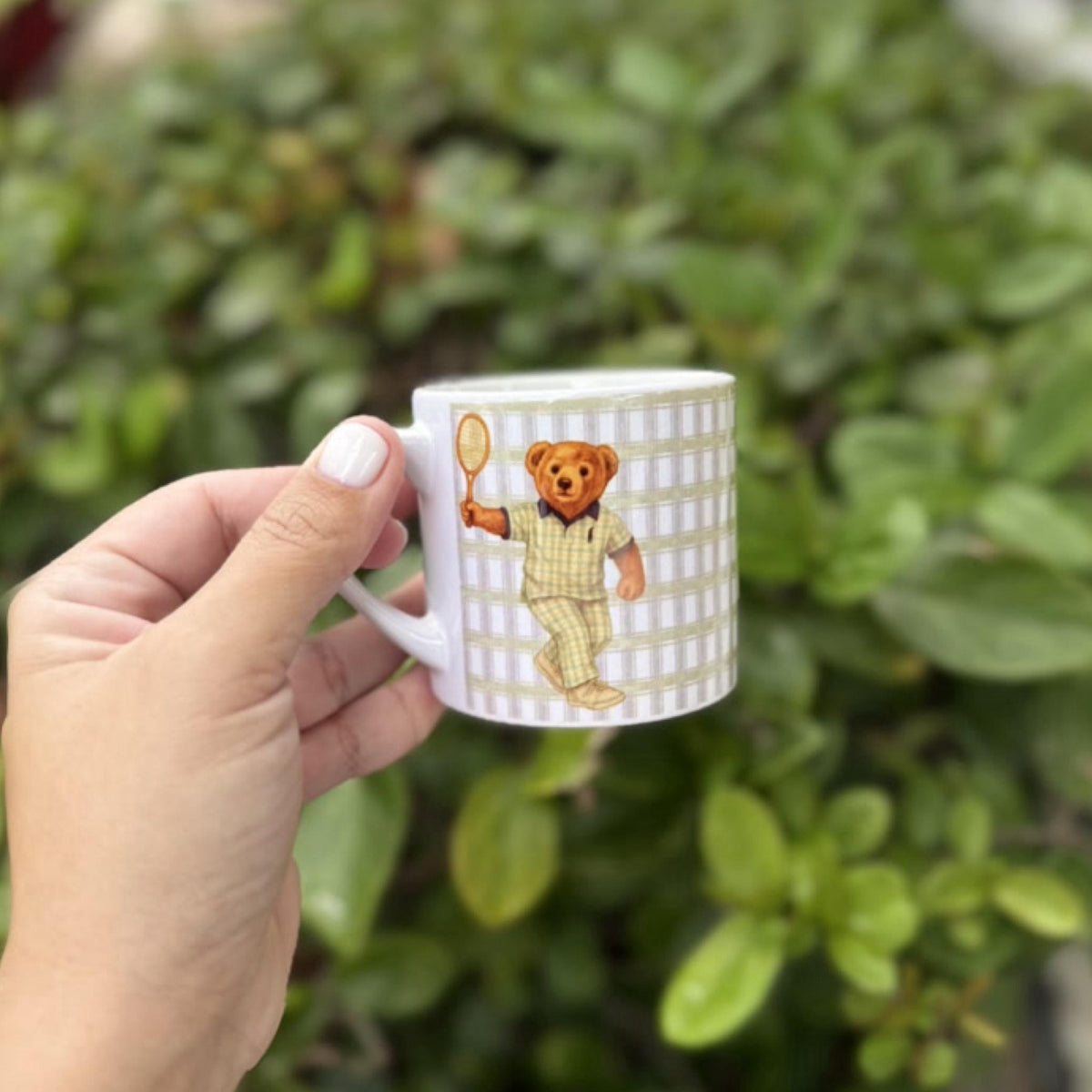 White ceramic espresso mug with a vintage tennis bear design