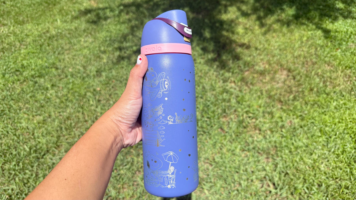 Back of a periwinkle Owala showing more engraved Snoopy artwork