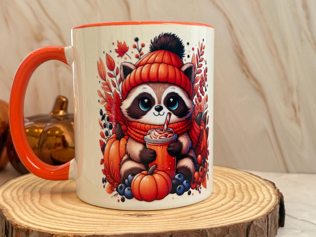 Side view of the fall raccoon and pumpkins print on an 11 oz mug
