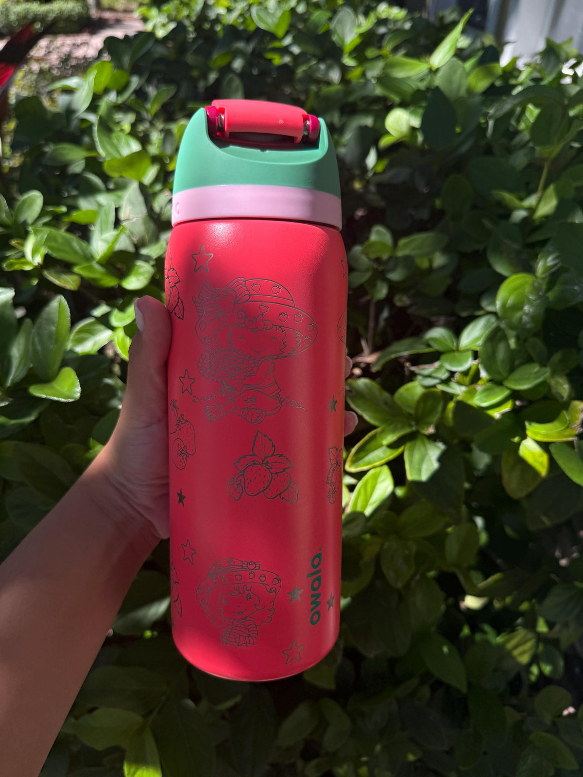 Close-up of strawberry engraving on a pink Owala FreeSip