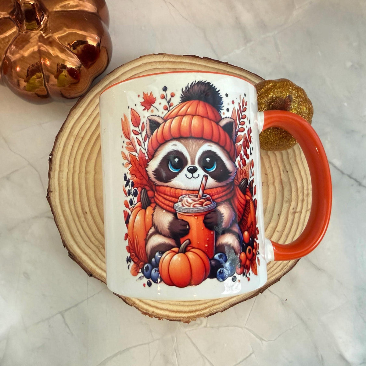 Autumn raccoon mug on a wooden board with fall decor