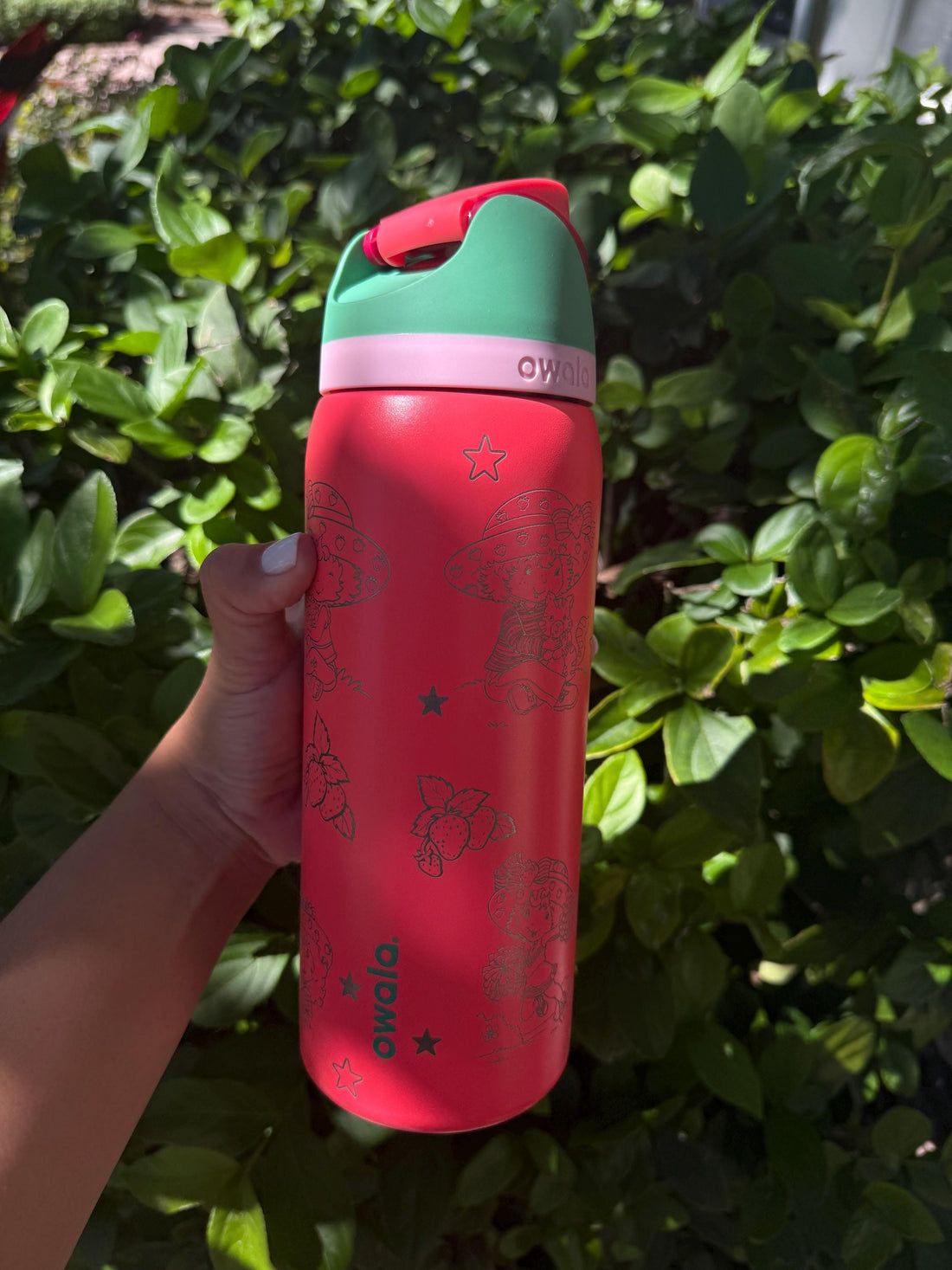 Pink Owala FreeSip with mint lid, laser engraved with a strawberry design