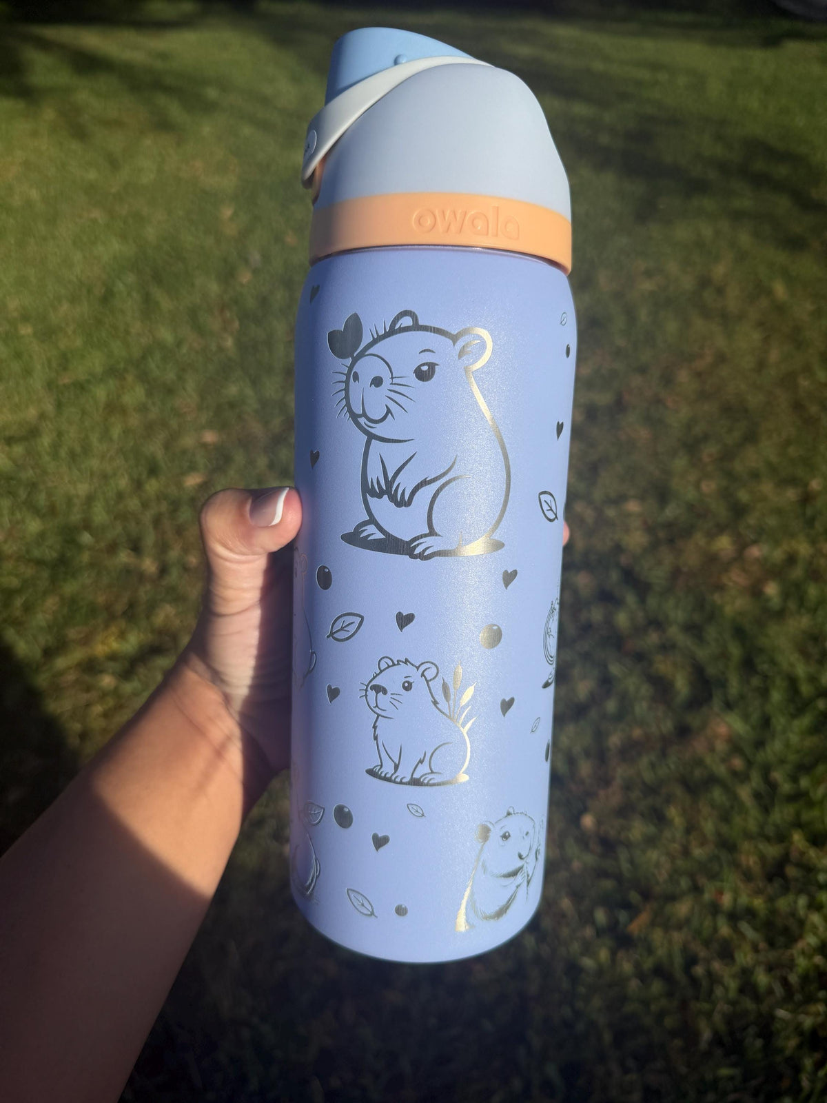 Periwinkle Owala FreeSip laser engraved with cute capybara designs