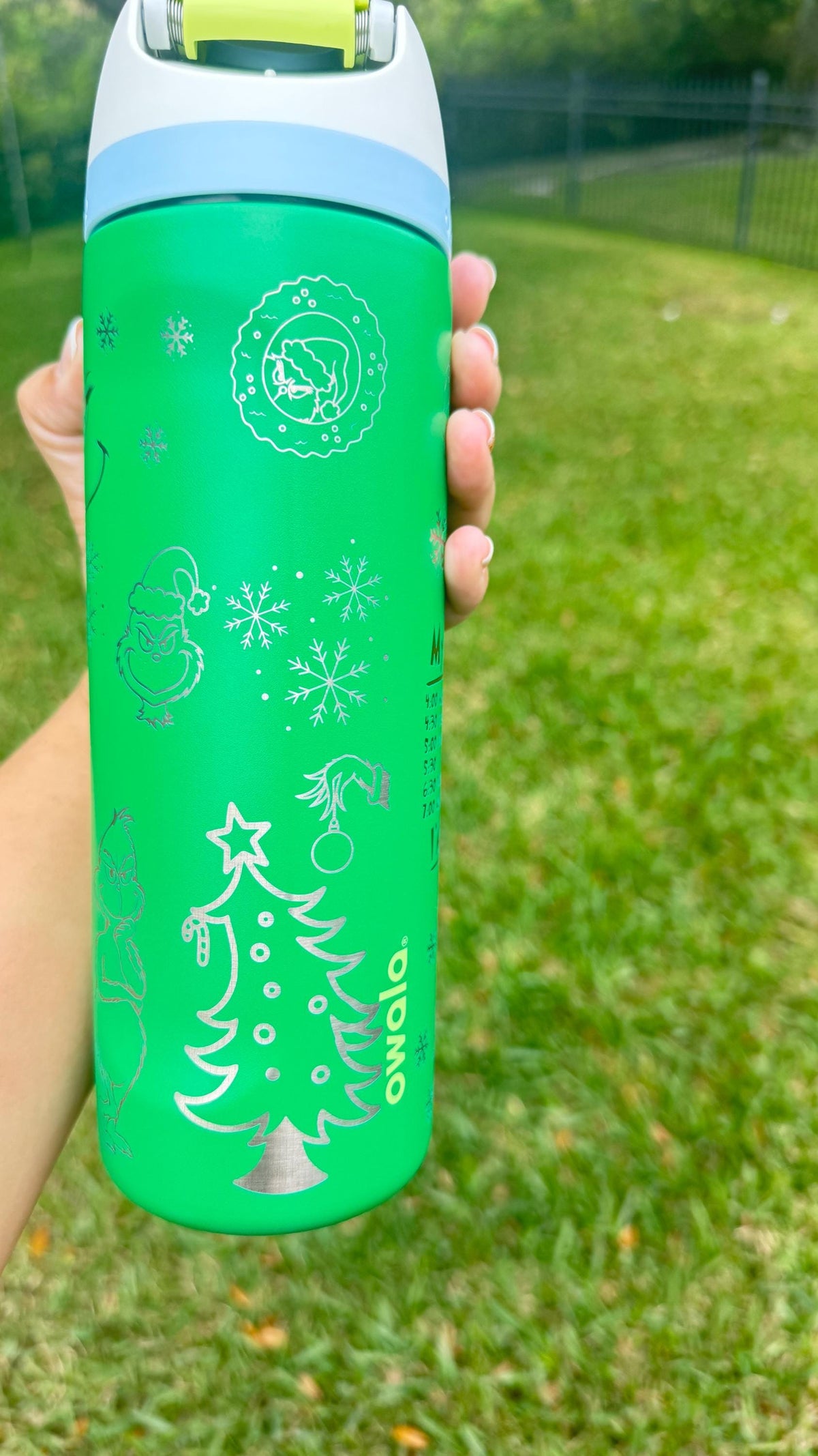 Christmas tree and ornaments engraved on a green Owala water bottle