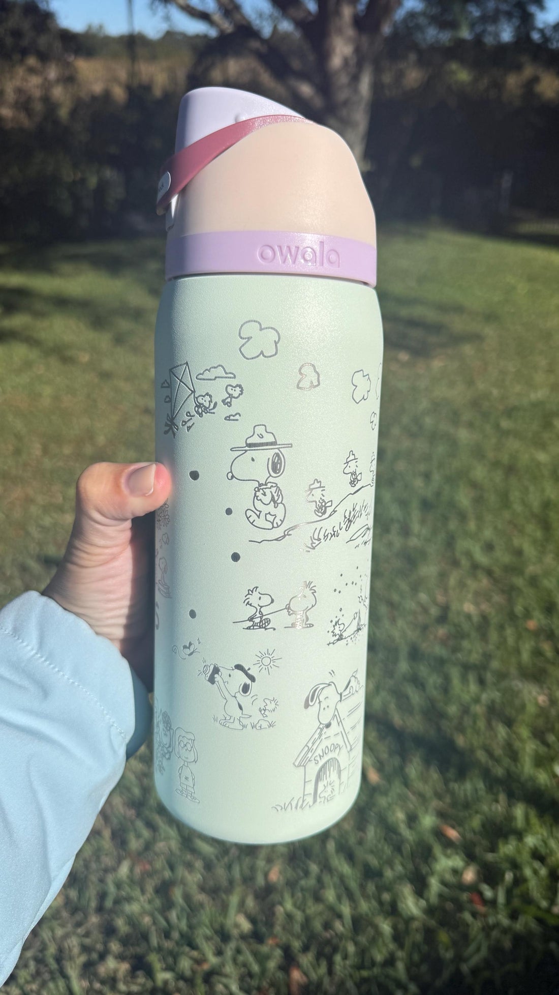 Mint green Owala FreeSip laser engraved with Snoopy and Peanuts characters