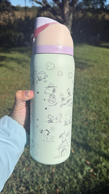 Mint green Owala FreeSip laser engraved with Snoopy and Peanuts characters