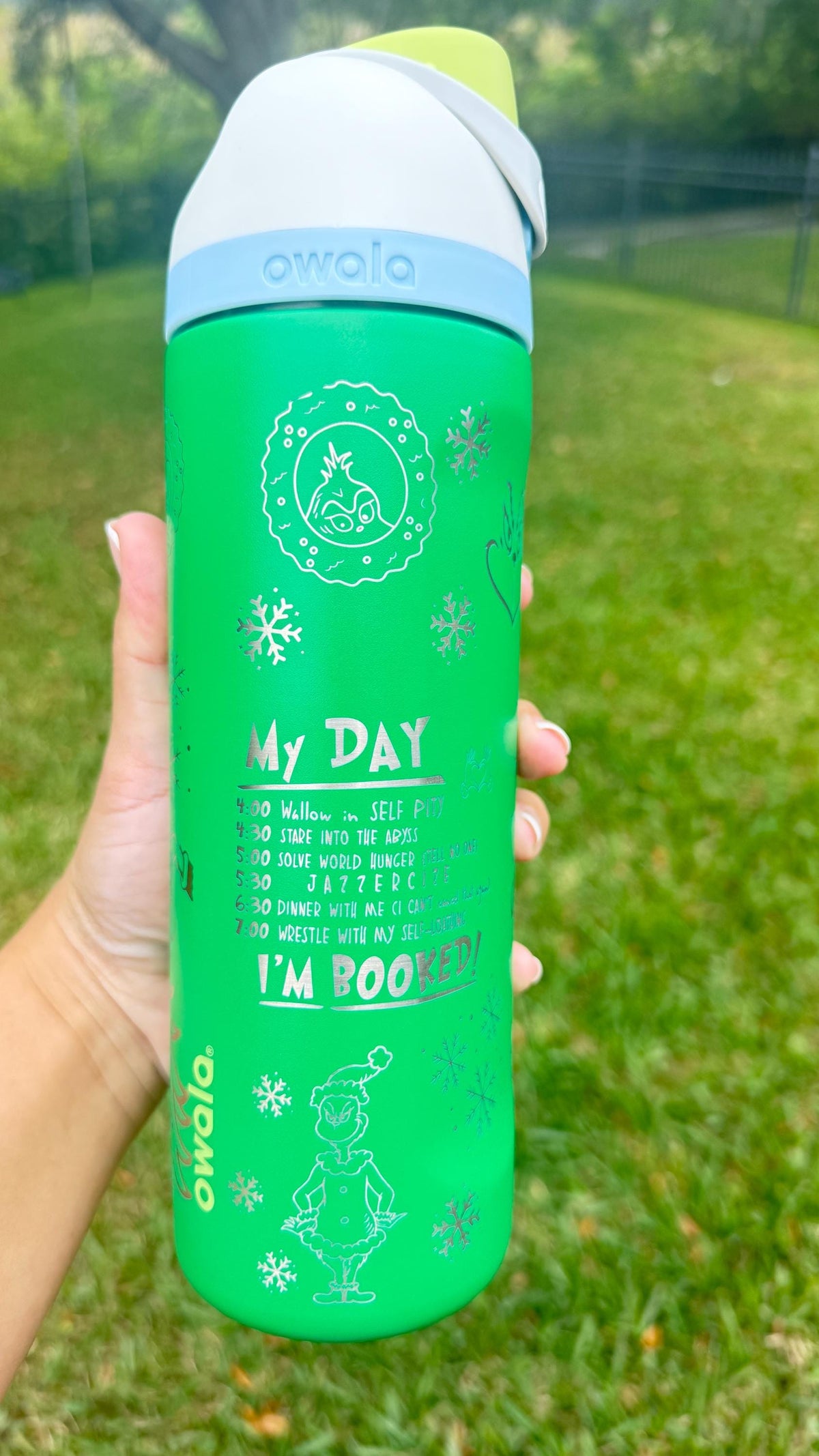 Engraved holiday quote on a green Grinch-inspired Owala