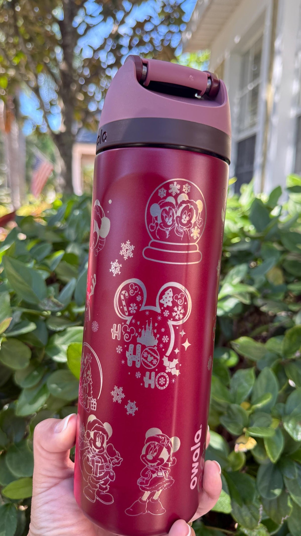 Close-up of the Mickey snow globe engraving on a red Owala