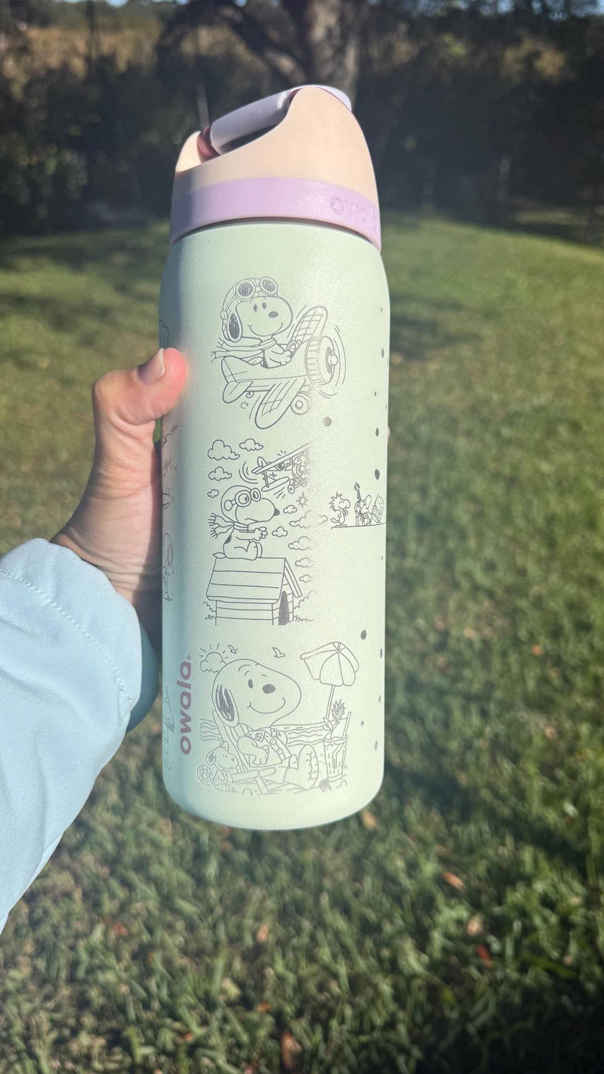 Close-up of Snoopy on his doghouse engraved on a mint Owala