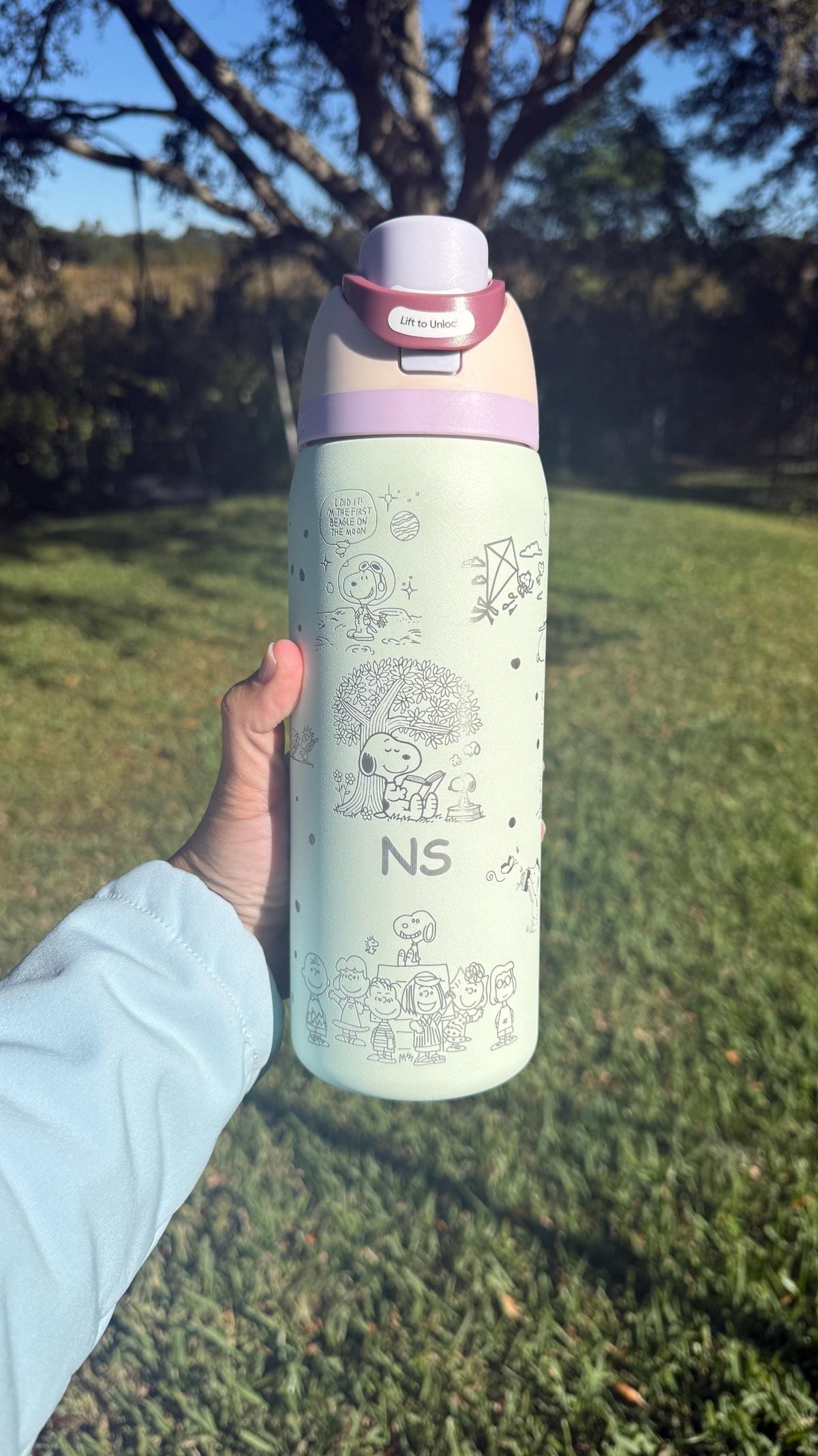 Mint green Owala with lavender lid and engraved Snoopy design