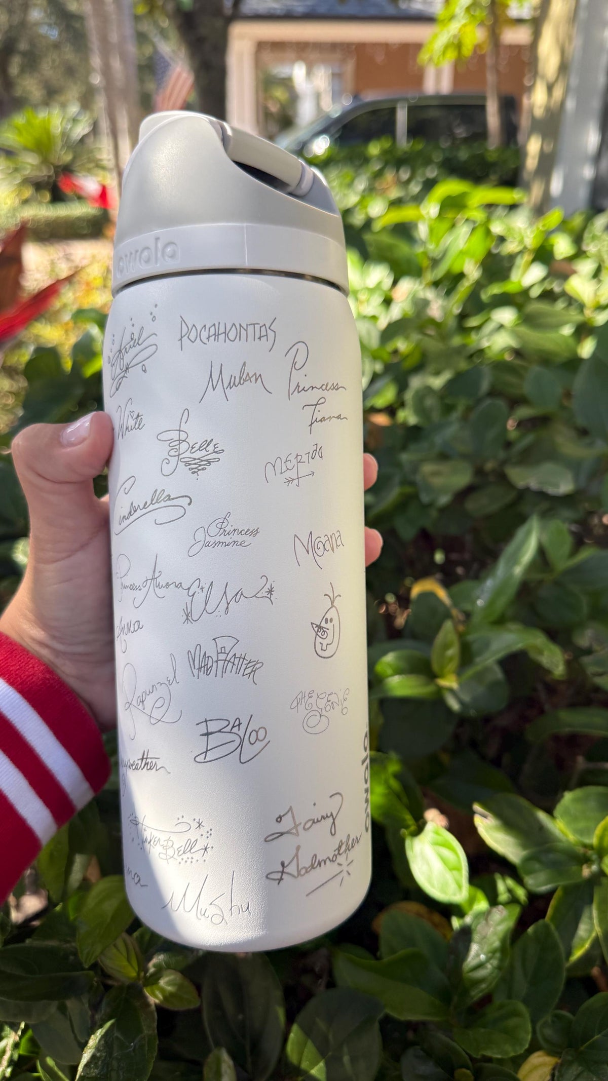 White Owala FreeSip covered in engraved autograph-style signatures