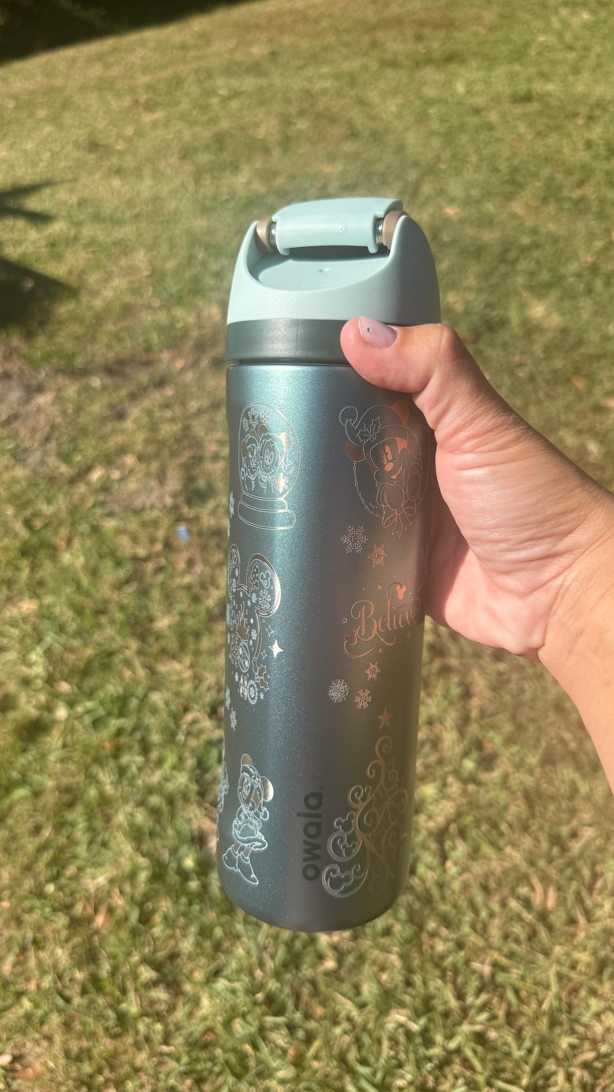 Slate teal Owala FreeSip laser engraved with a Mickey-inspired Christmas design