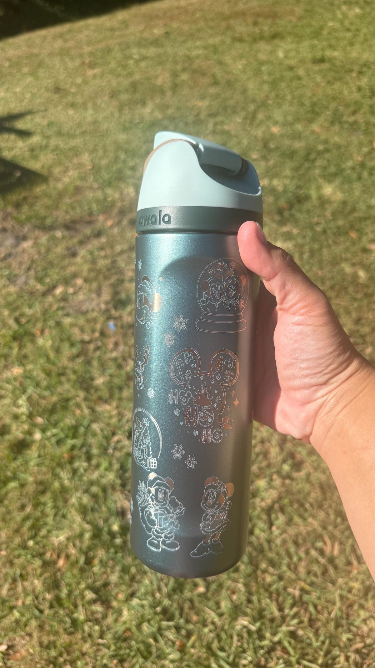 Close-up of snowflake engraving on a teal Christmas Owala