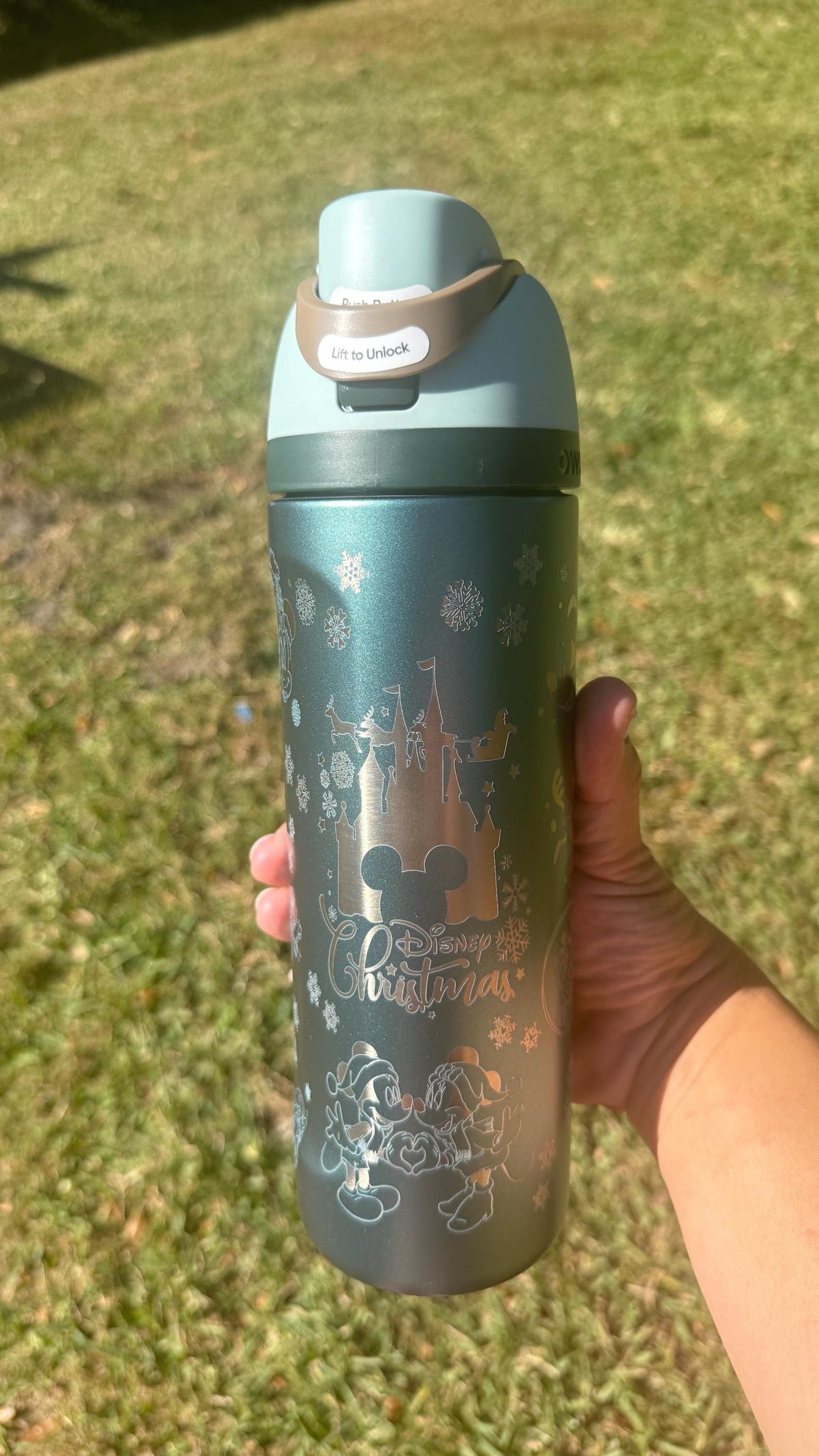 Slate teal engraved Owala FreeSip held outdoors