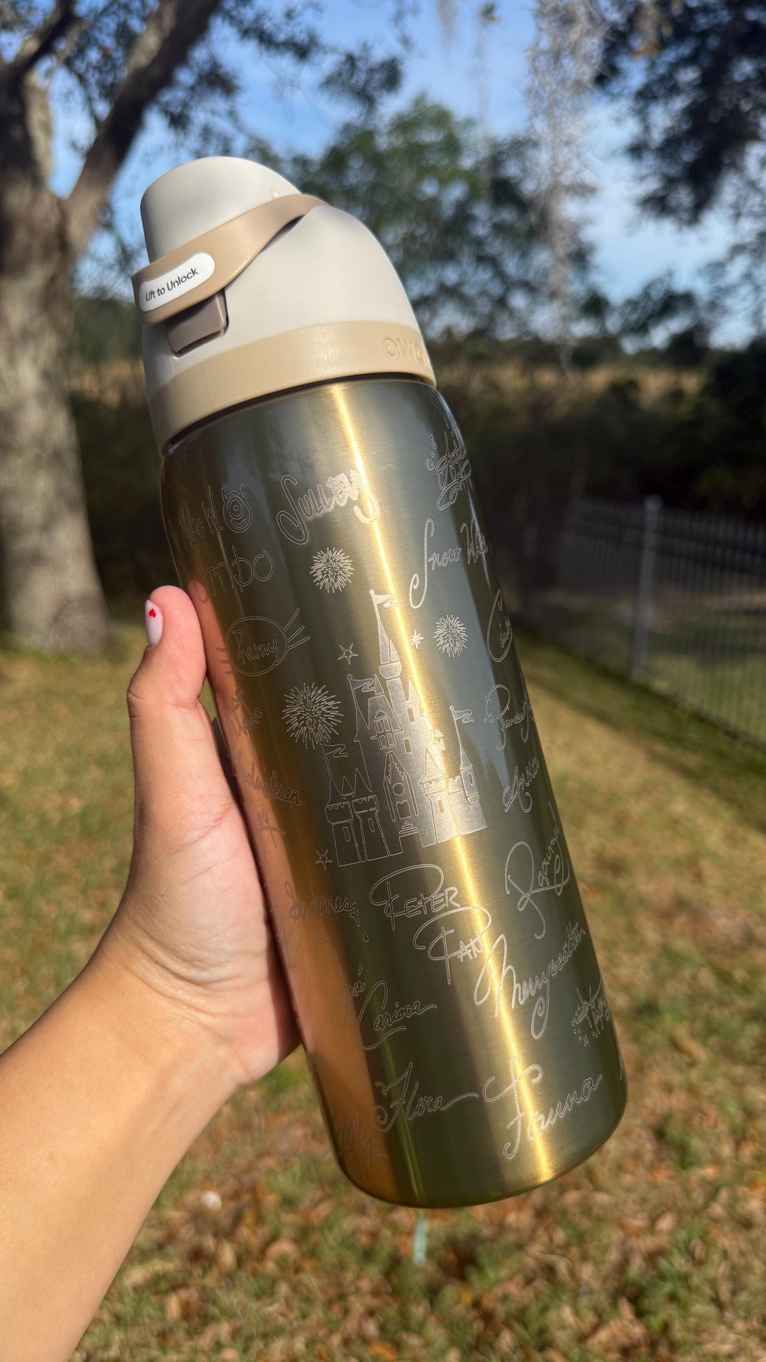 Gold Owala FreeSip laser engraved with Disney-inspired character signatures