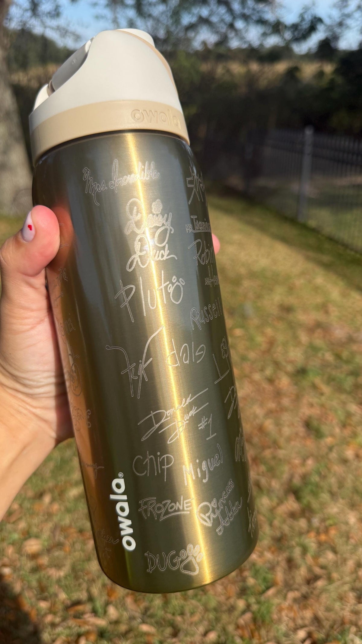Close-up of character signature engraving on a gold 32 oz Owala