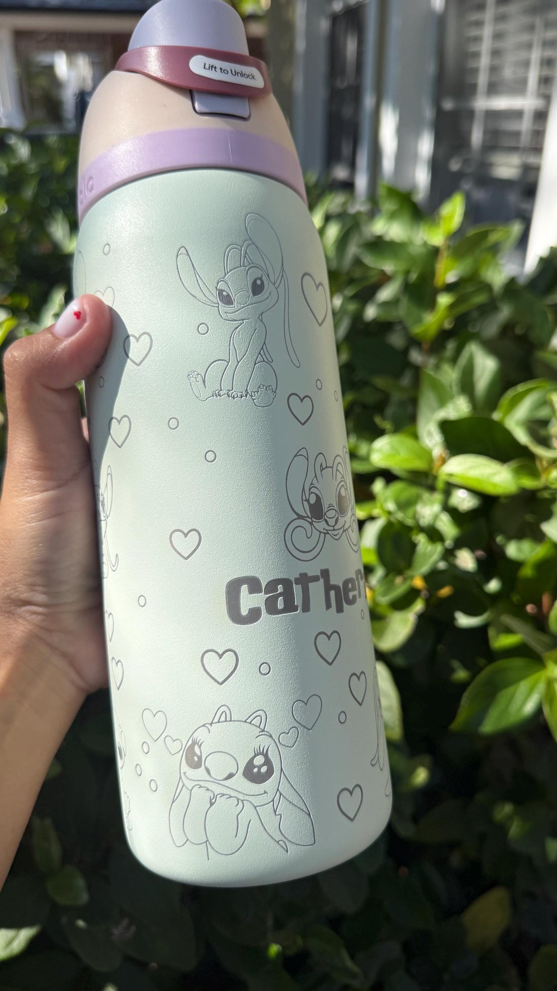 Mint green Owala FreeSip laser engraved with Angel and Stitch-inspired art and the name Catherine