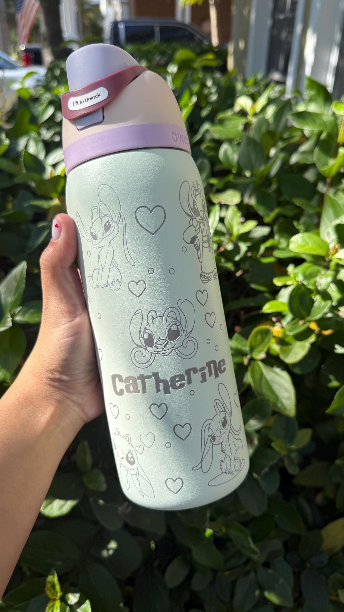 Mint green Owala FreeSip laser engraved with Angel and Stitch-inspired art and the name Catherine