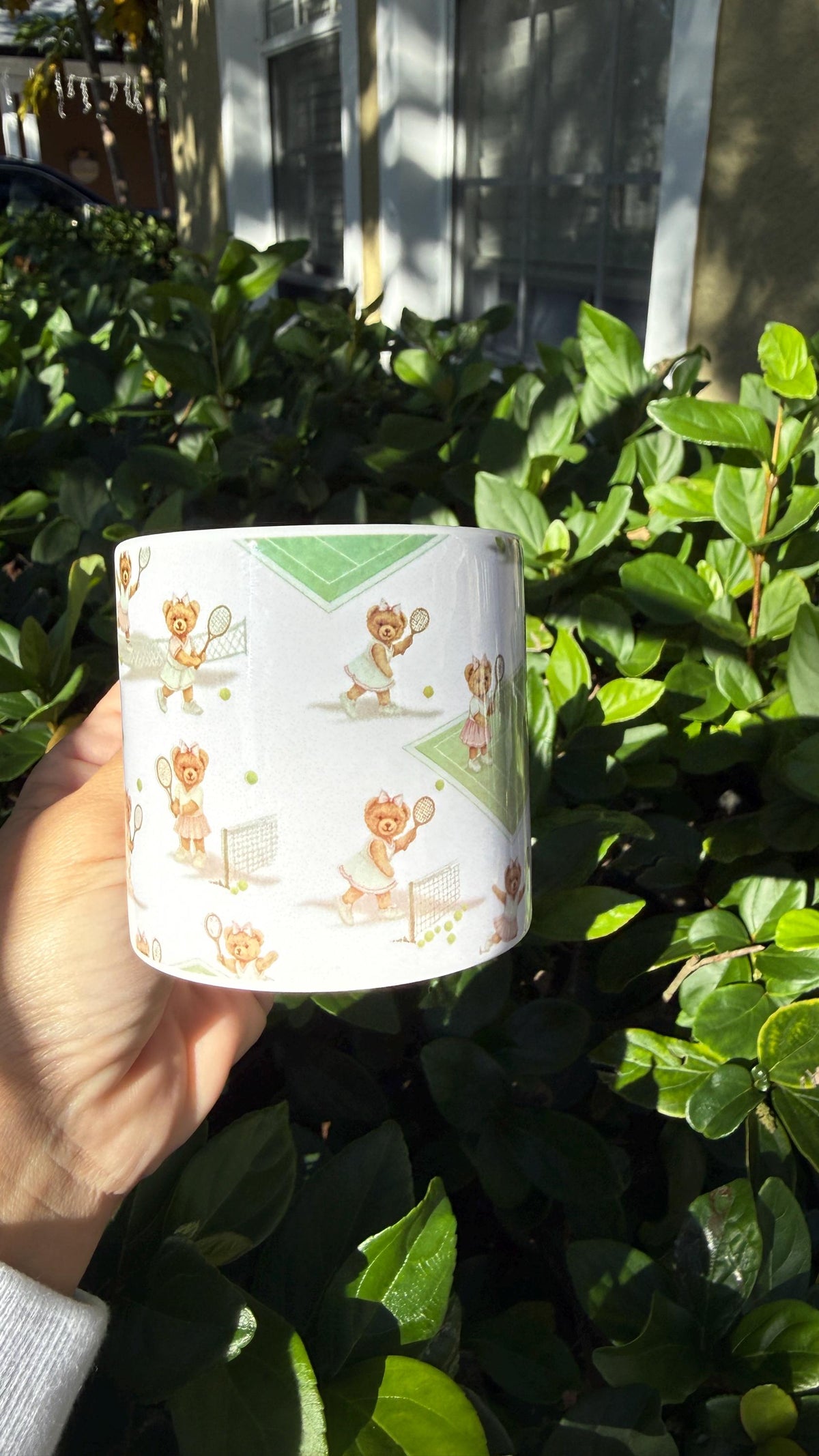 White enamel mug with a vintage tennis bear pattern