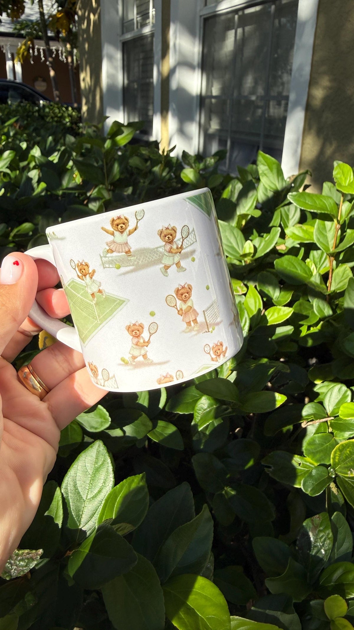 Side view of a tennis bear enamel coffee mug