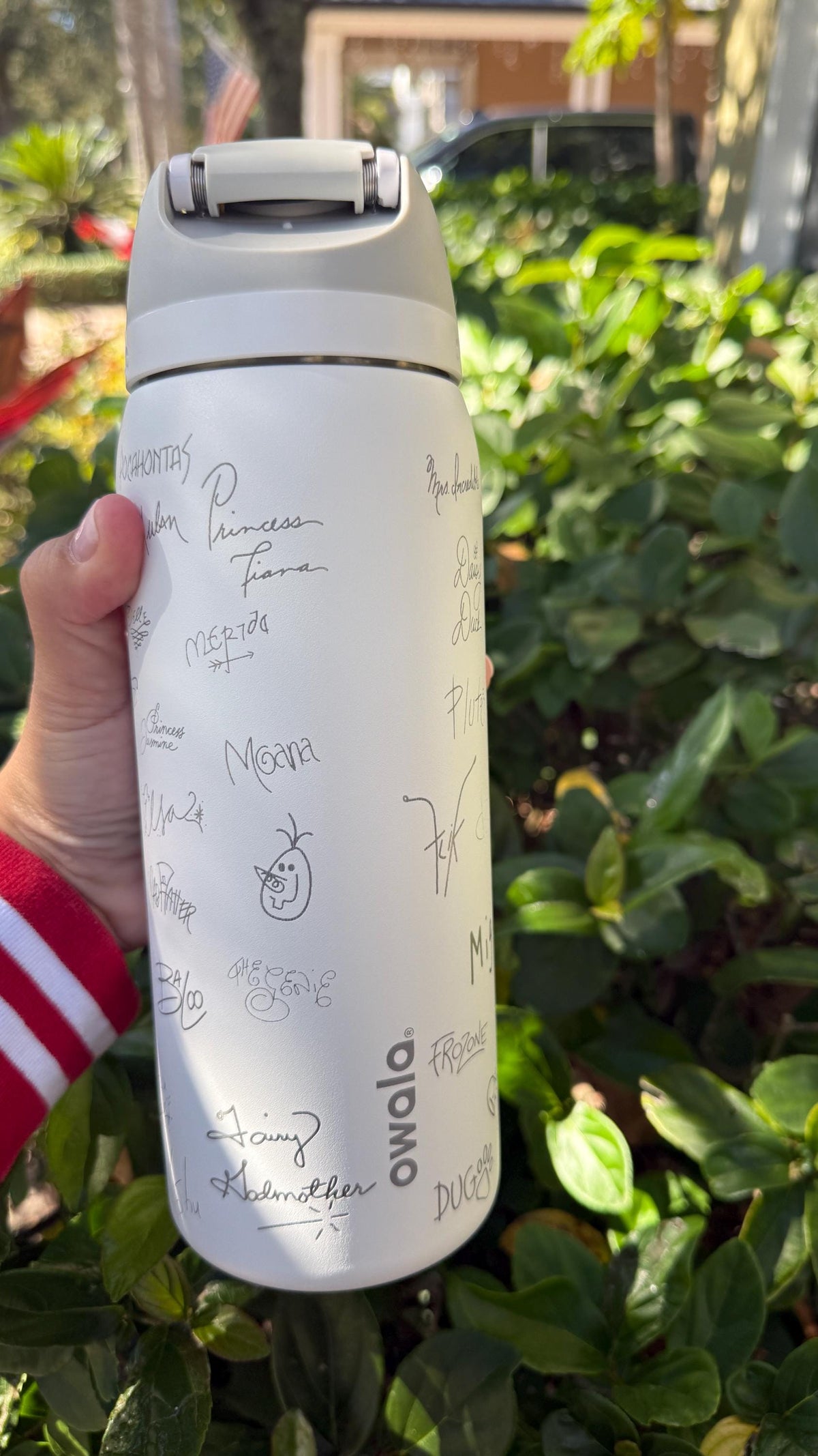 Close-up of engraved character signatures on a white Owala