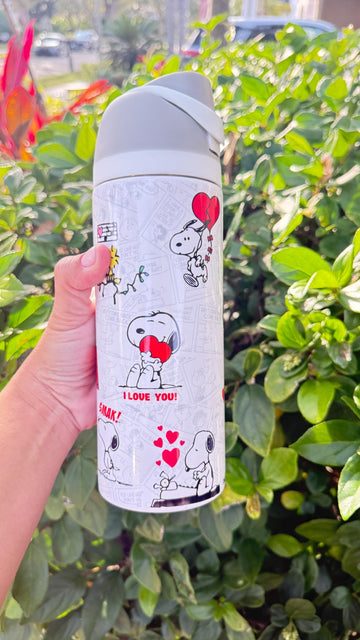 White tumbler with a Snoopy Valentine's Day design with red hearts
