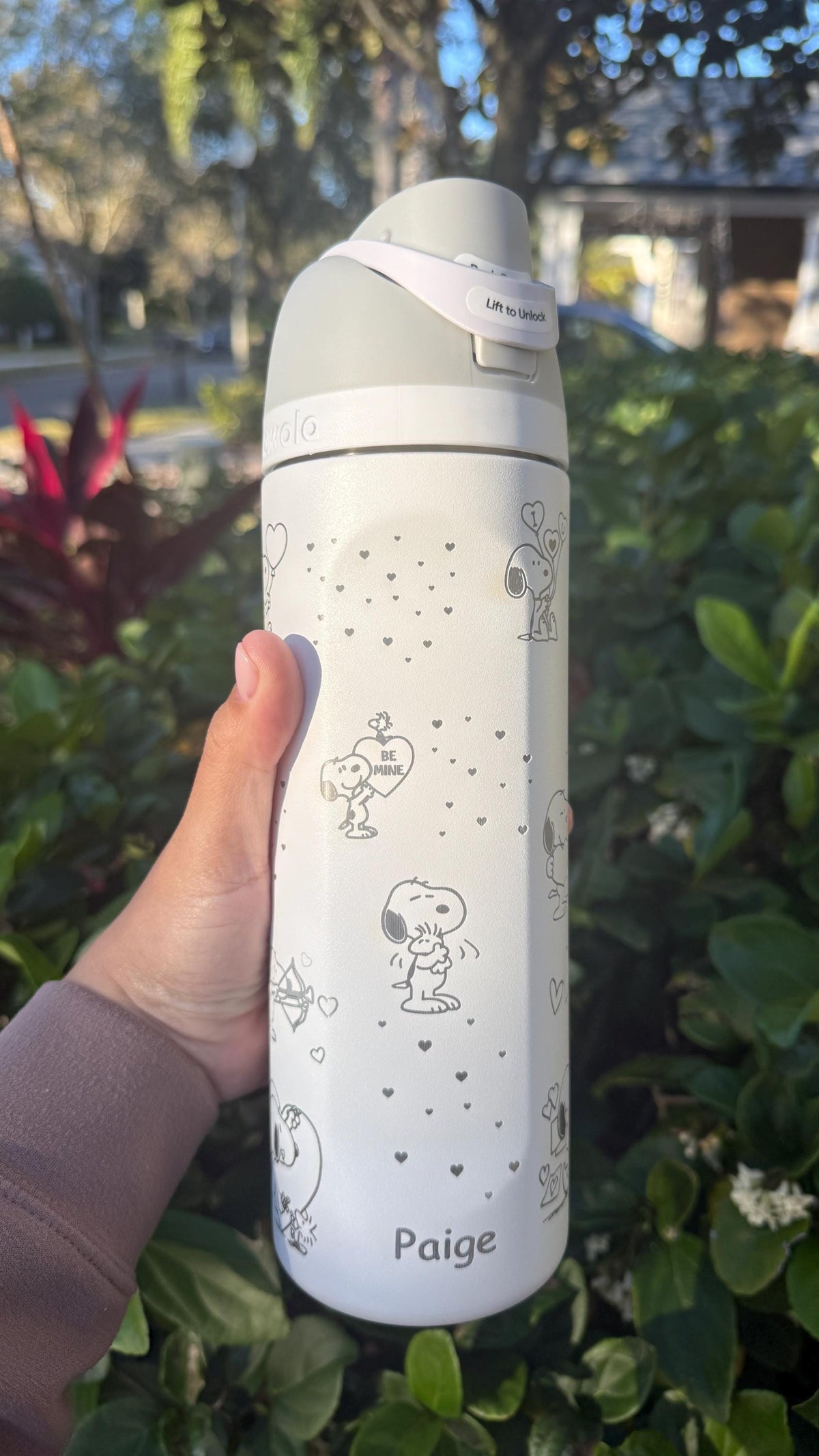 White Snoopy Valentine's Owala FreeSip held outdoors