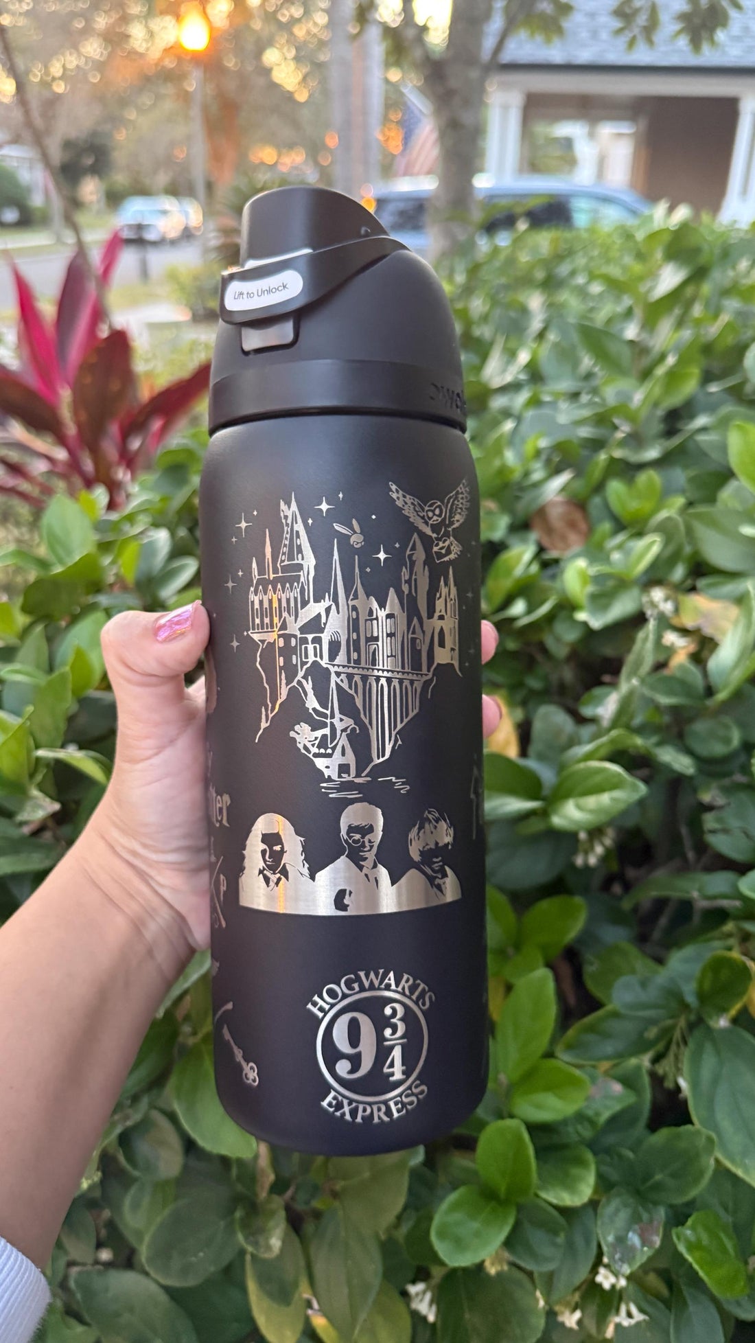Black Owala FreeSip laser engraved with a Harry Potter-inspired castle and wizard design