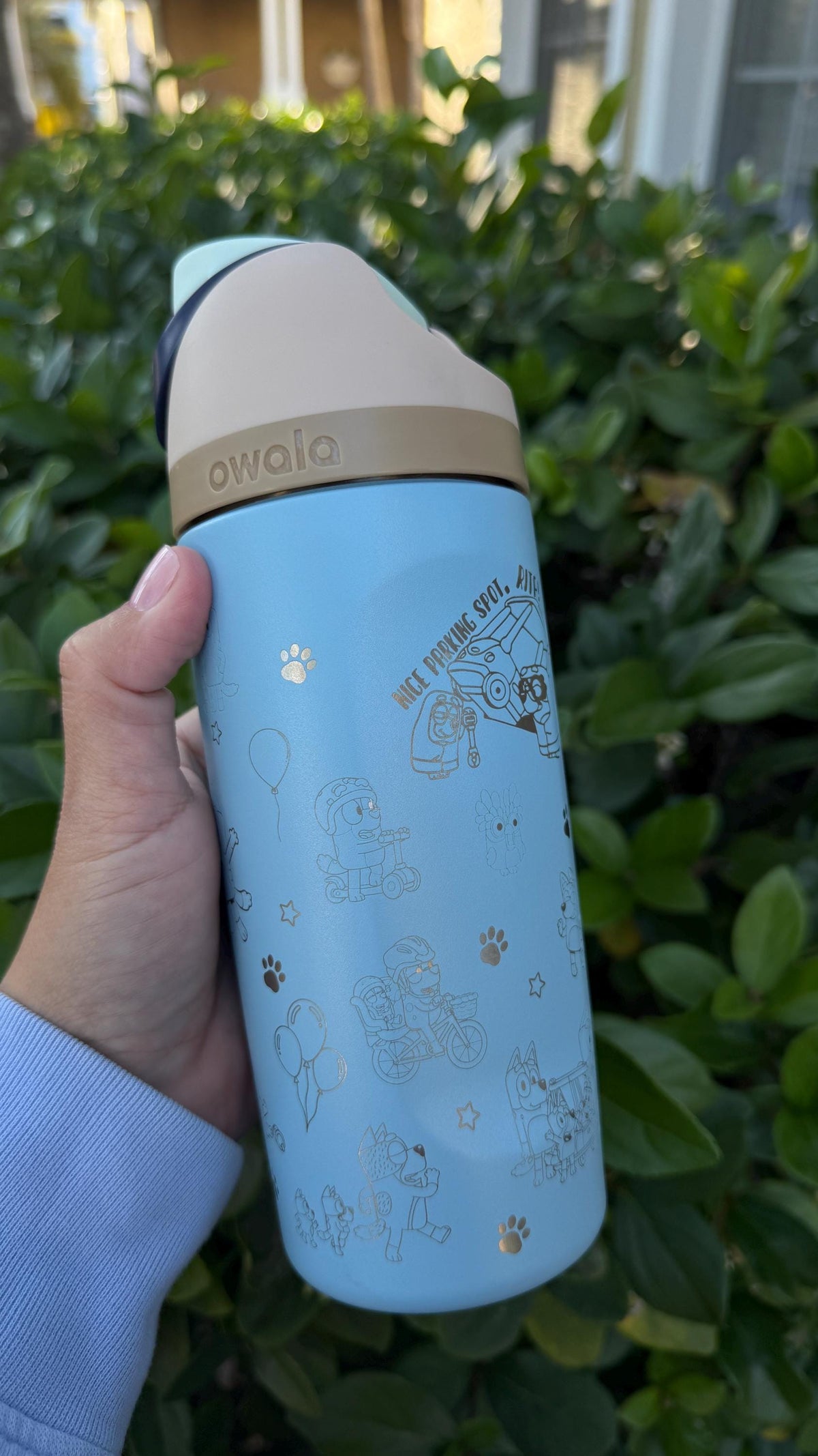 Back of a light blue Owala FreeSip with engraved kids design