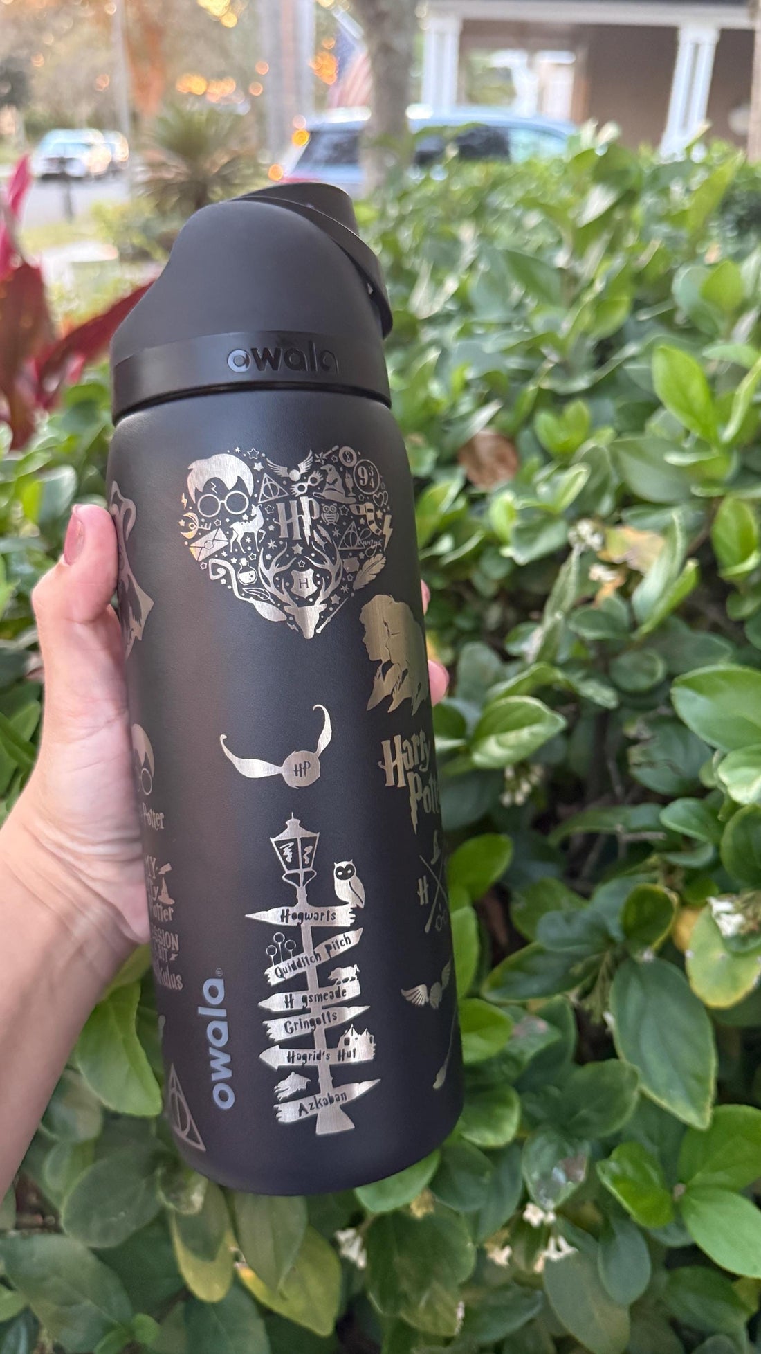 Black Owala FreeSip laser engraved with a Harry Potter-inspired castle and wizard design