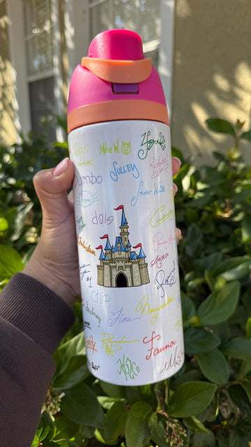 White FreeSip-style tumbler printed with colorful Disney-inspired character signatures and a castle