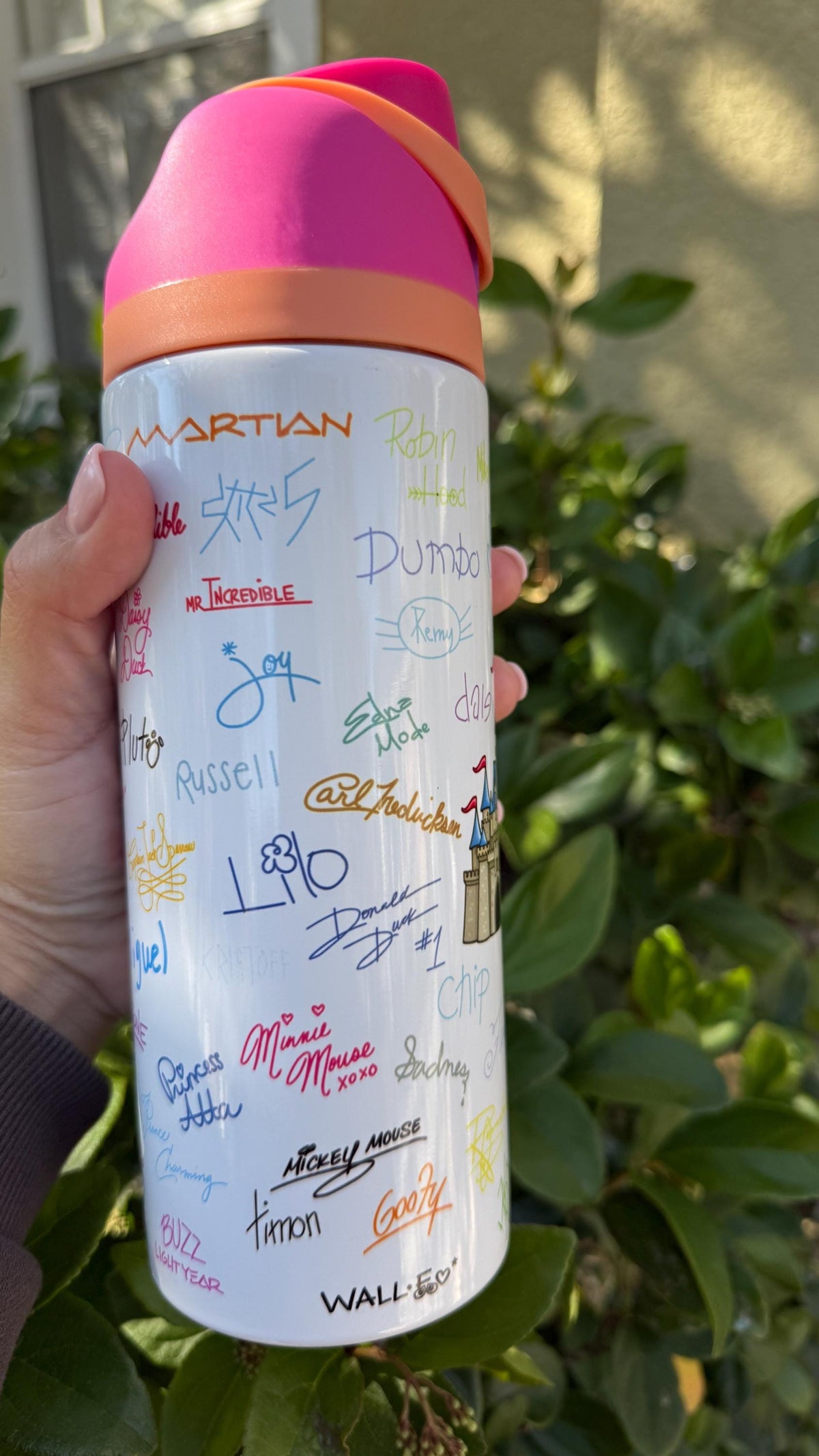 Back of a white signatures tumbler with colorful printed autographs
