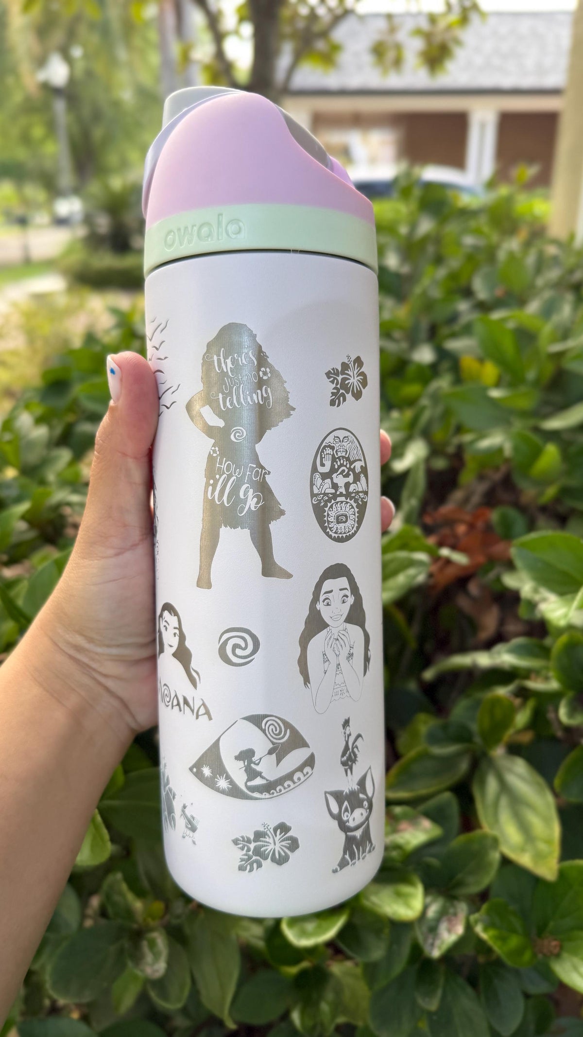 Side view of a white Owala with engraved Moana-inspired artwork