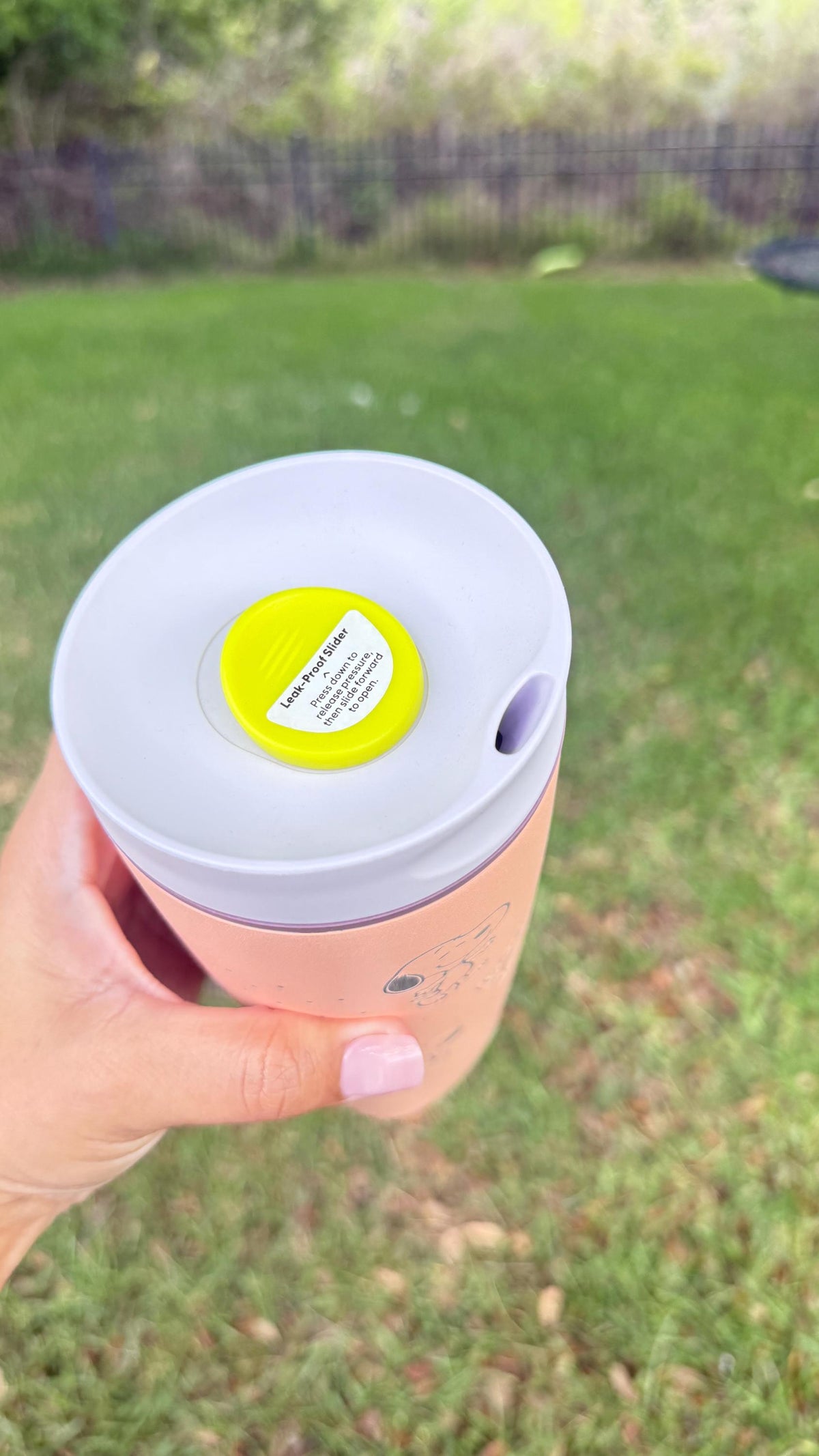 Top view of the Owala SmoothSip lid on a pink engraved tumbler
