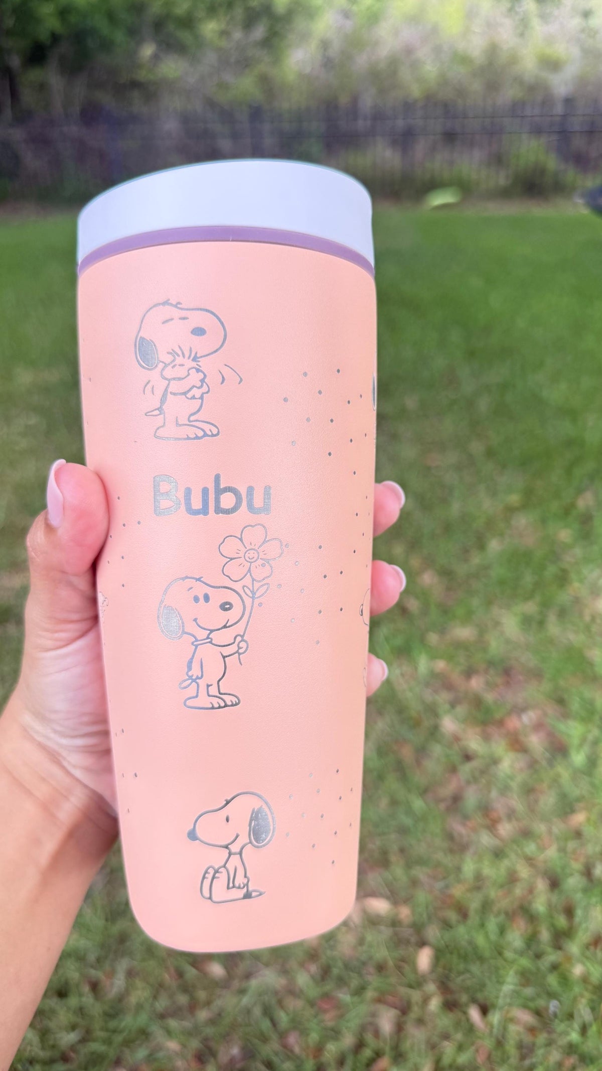 Pink Owala SmoothSip tumbler laser engraved with Snoopy and Peanuts characters and a sample name