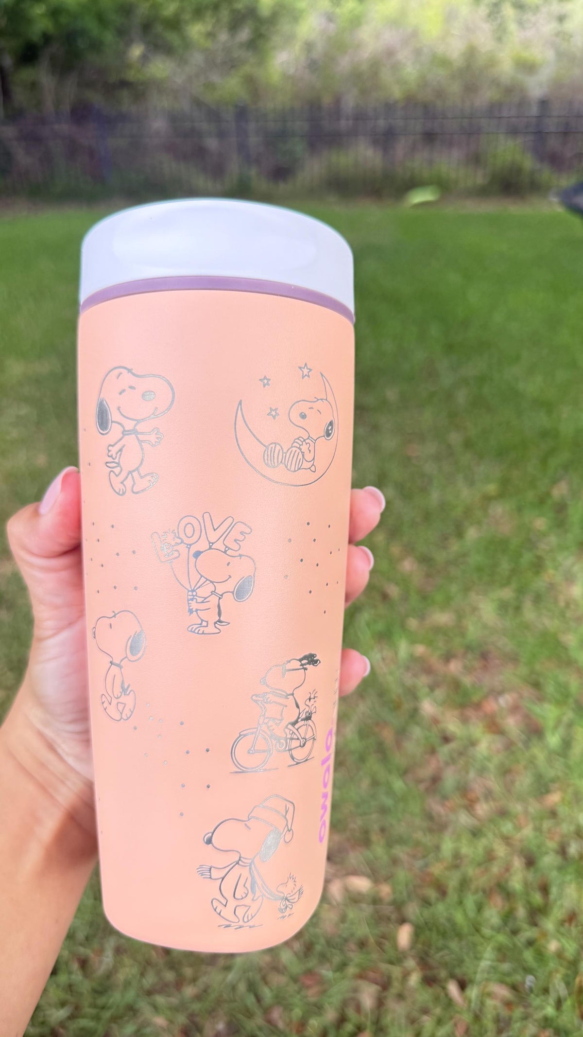 Back of the pink Owala SmoothSip showing more engraved Peanuts characters