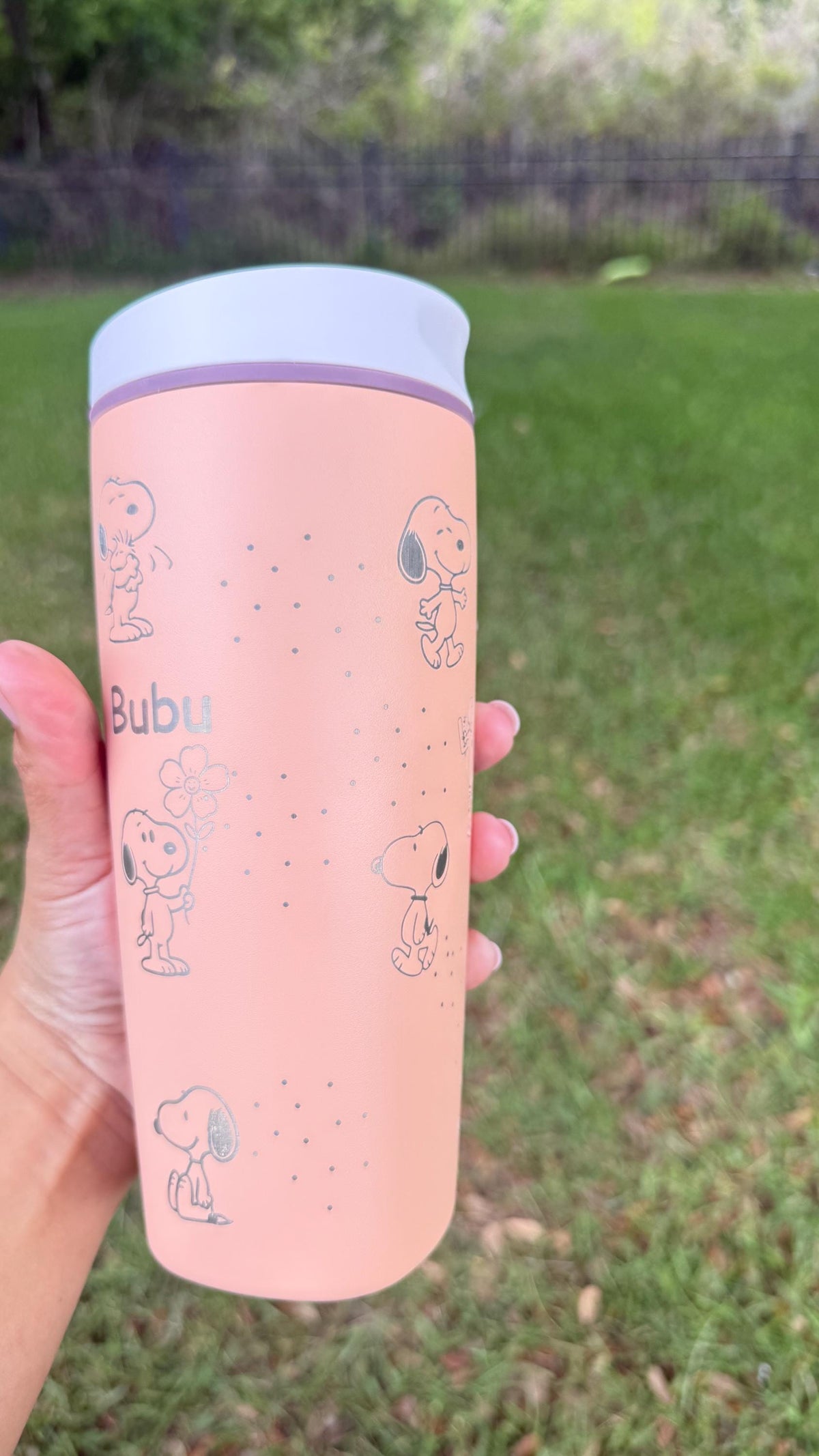 Full-length view of a pink Owala SmoothSip with Snoopy laser engraving and name