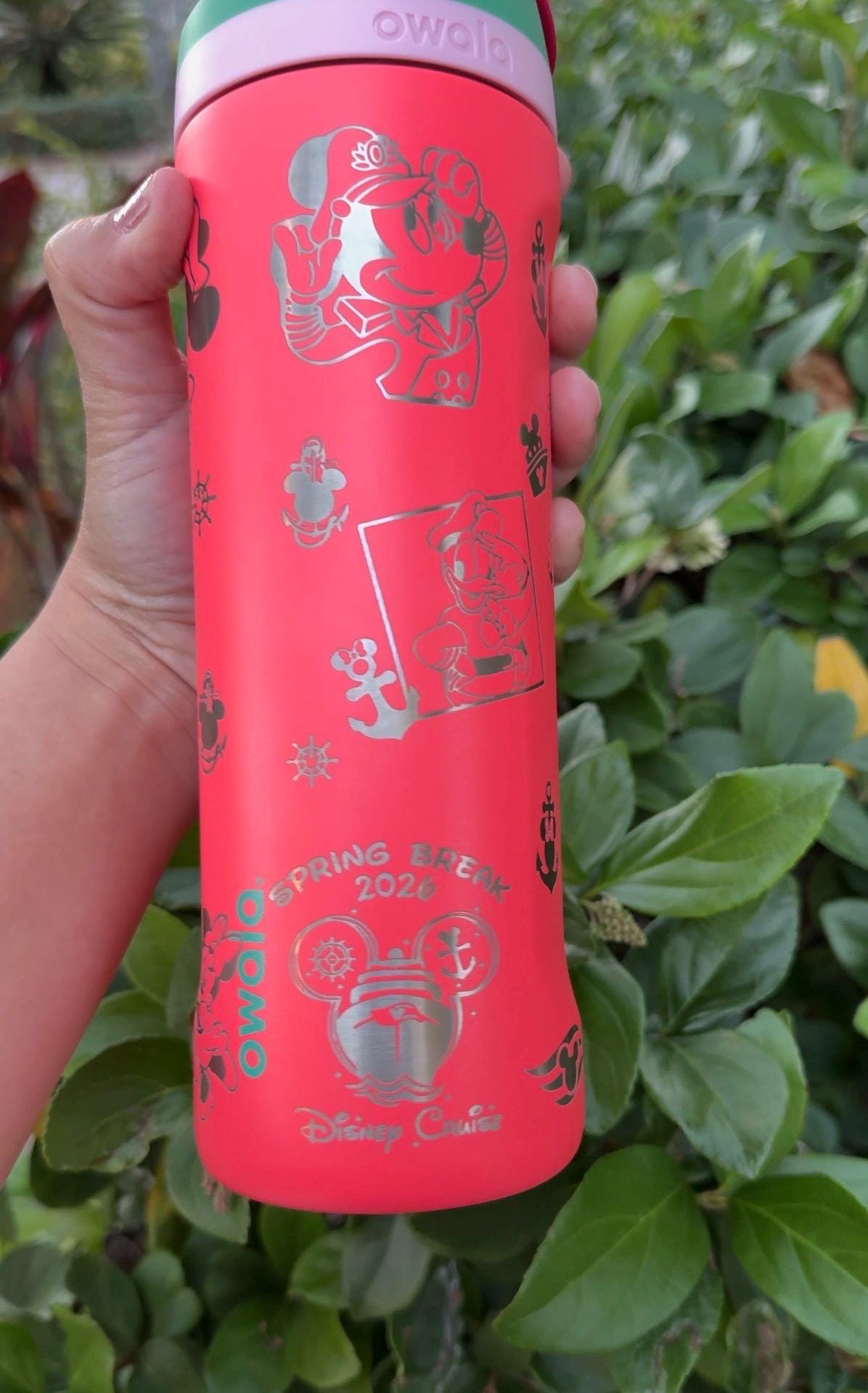 Close-up of the cruise-themed engraving on a coral Owala