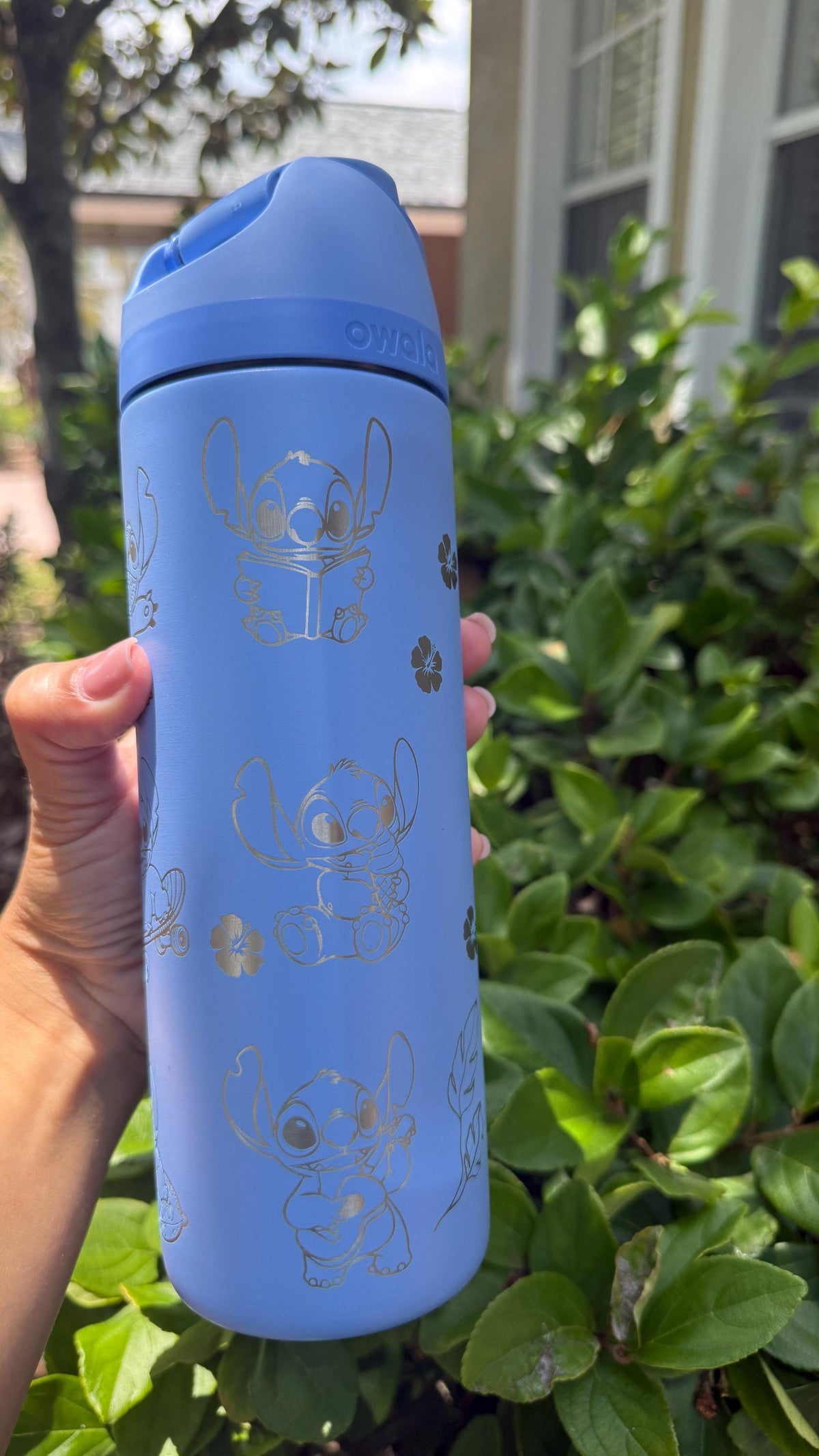 Back of a blue Owala FreeSip showing more Stitch-inspired engraving
