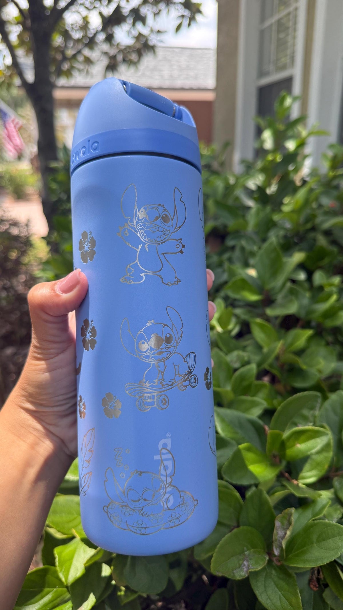 Side view of a blue Owala with engraved Stitch artwork